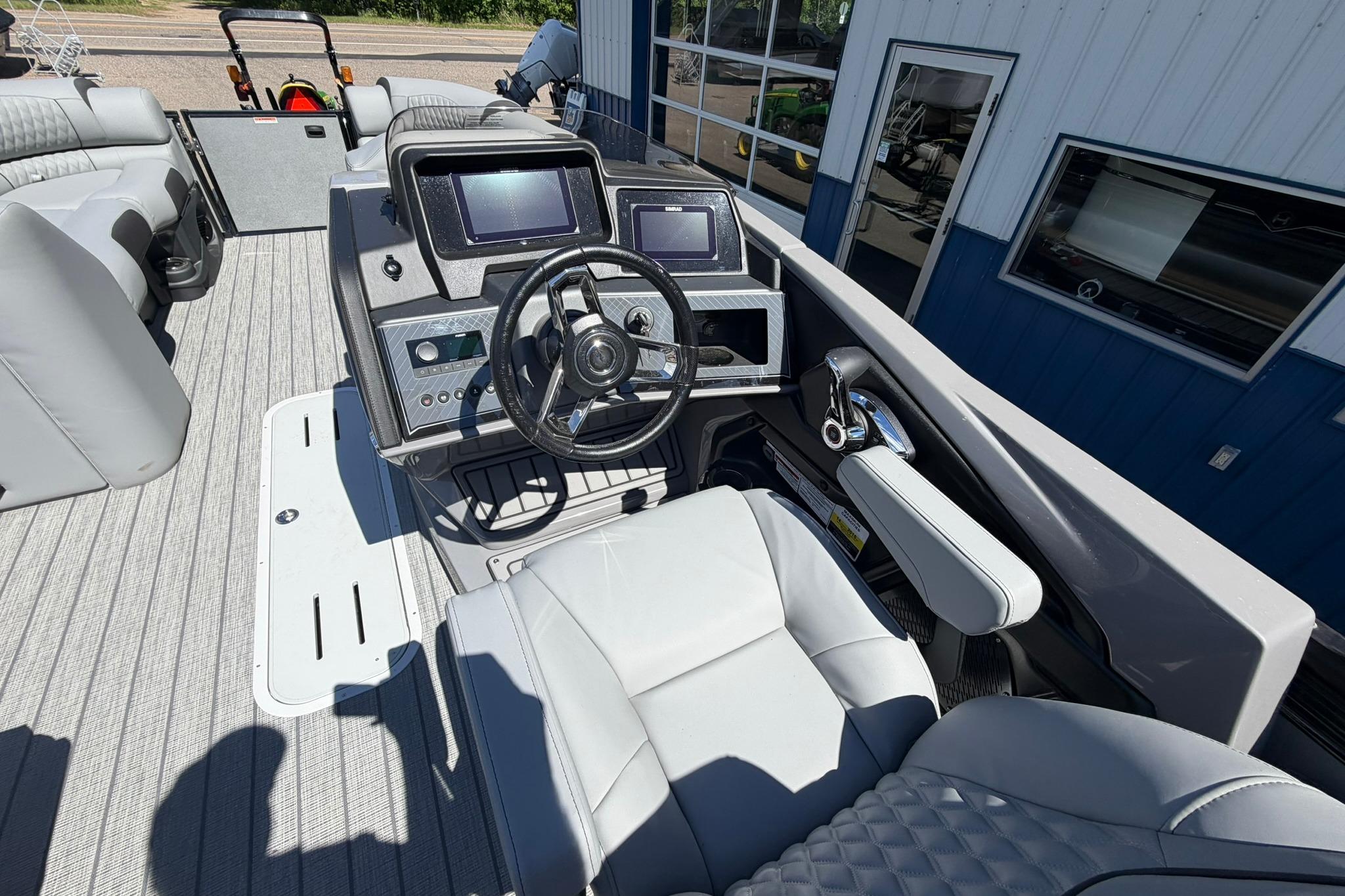 2026 Avalon Catalina Quad Lounge Shift boat interior with modern steering console and plush seating.