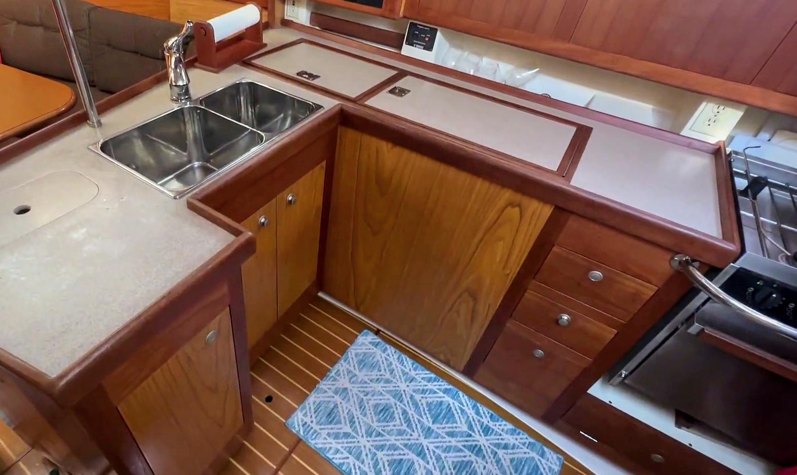 Hunter 380 yacht kitchen interior with dual sink, wooden cabinets, and modern appliances, 2001 model.