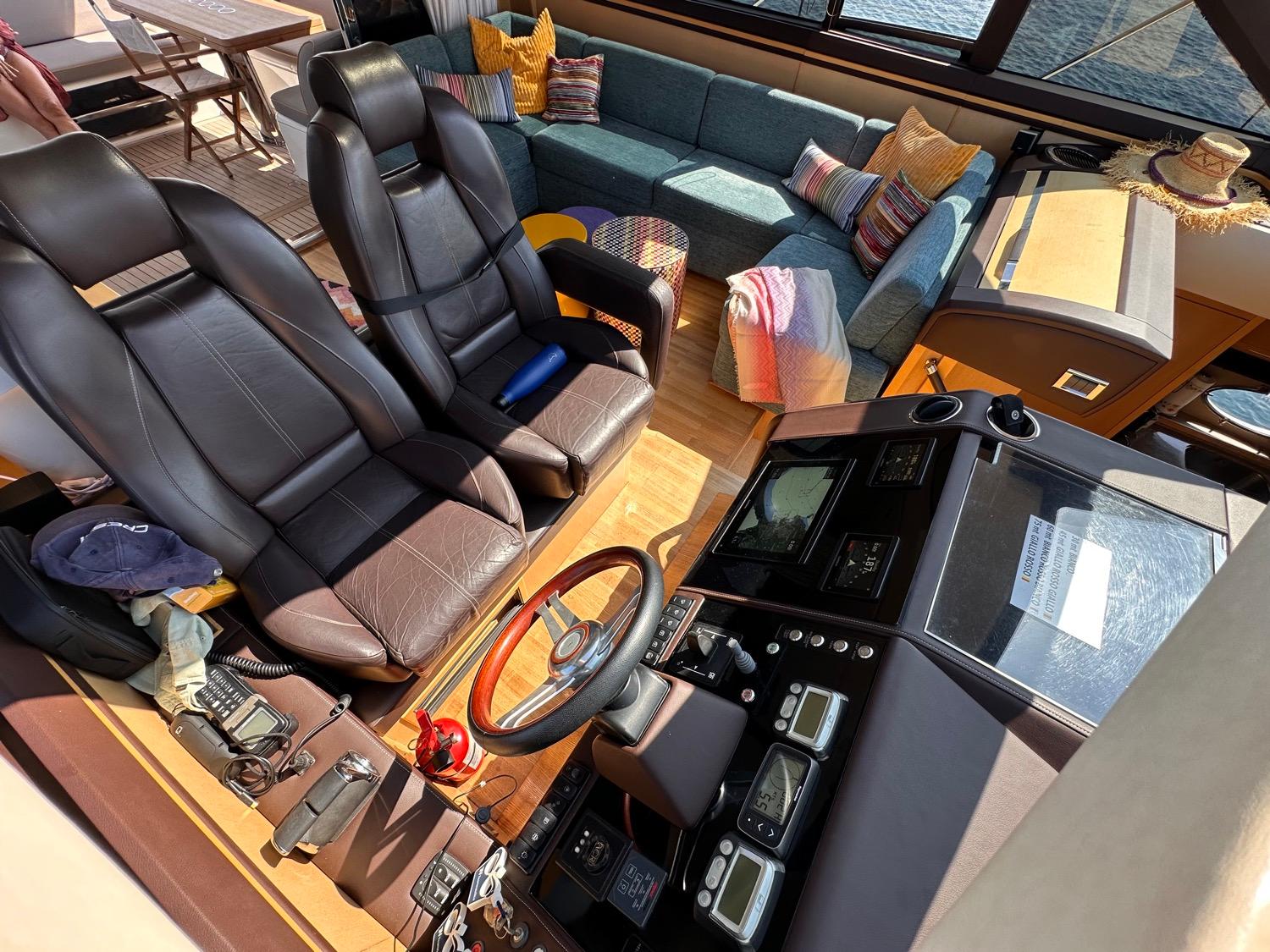 Luxurious 2009 Princess V62 yacht interior with leather seats and cozy lounge area.