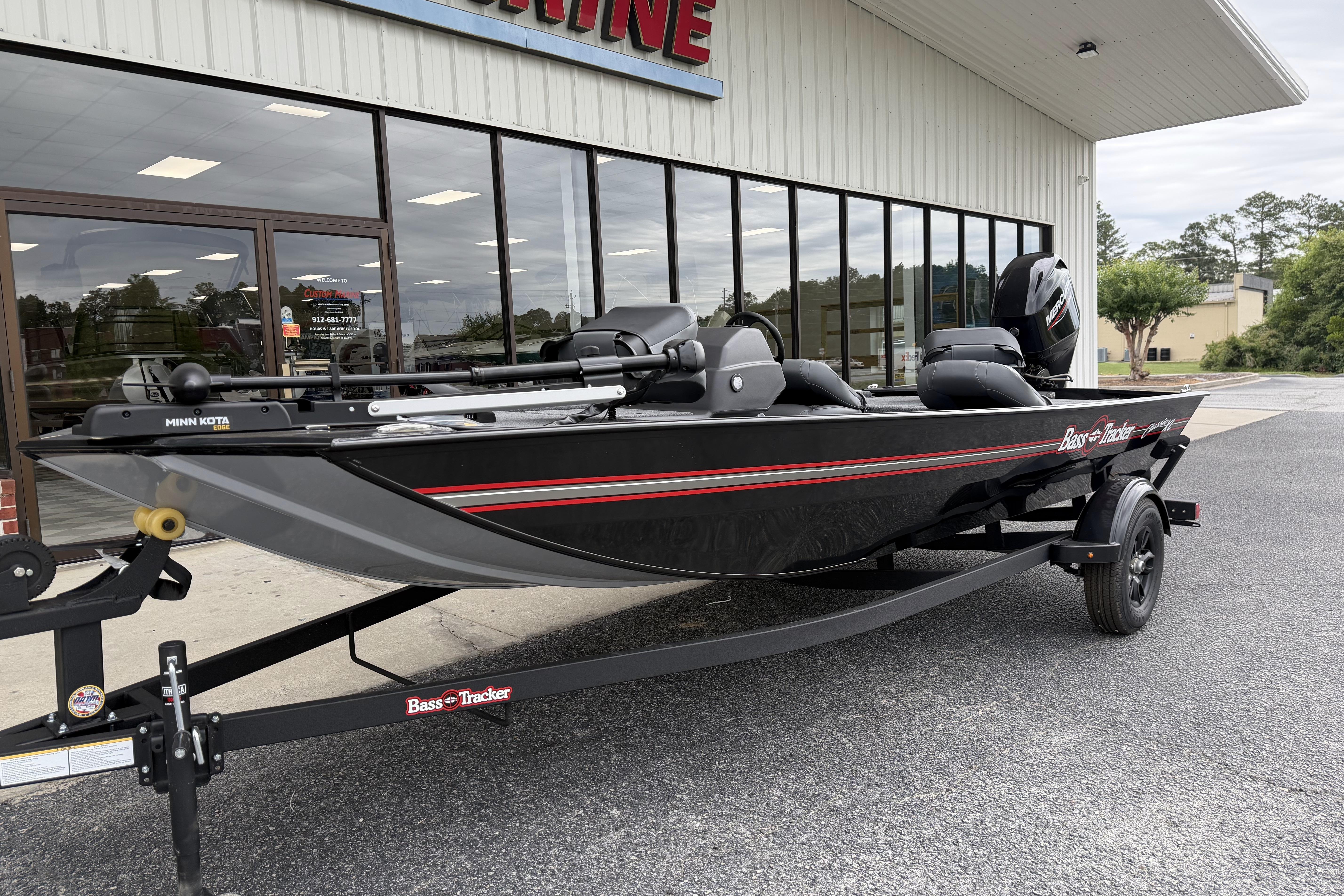 2026 Tracker Bass Tracker Classic XL boat on trailer outside dealership.