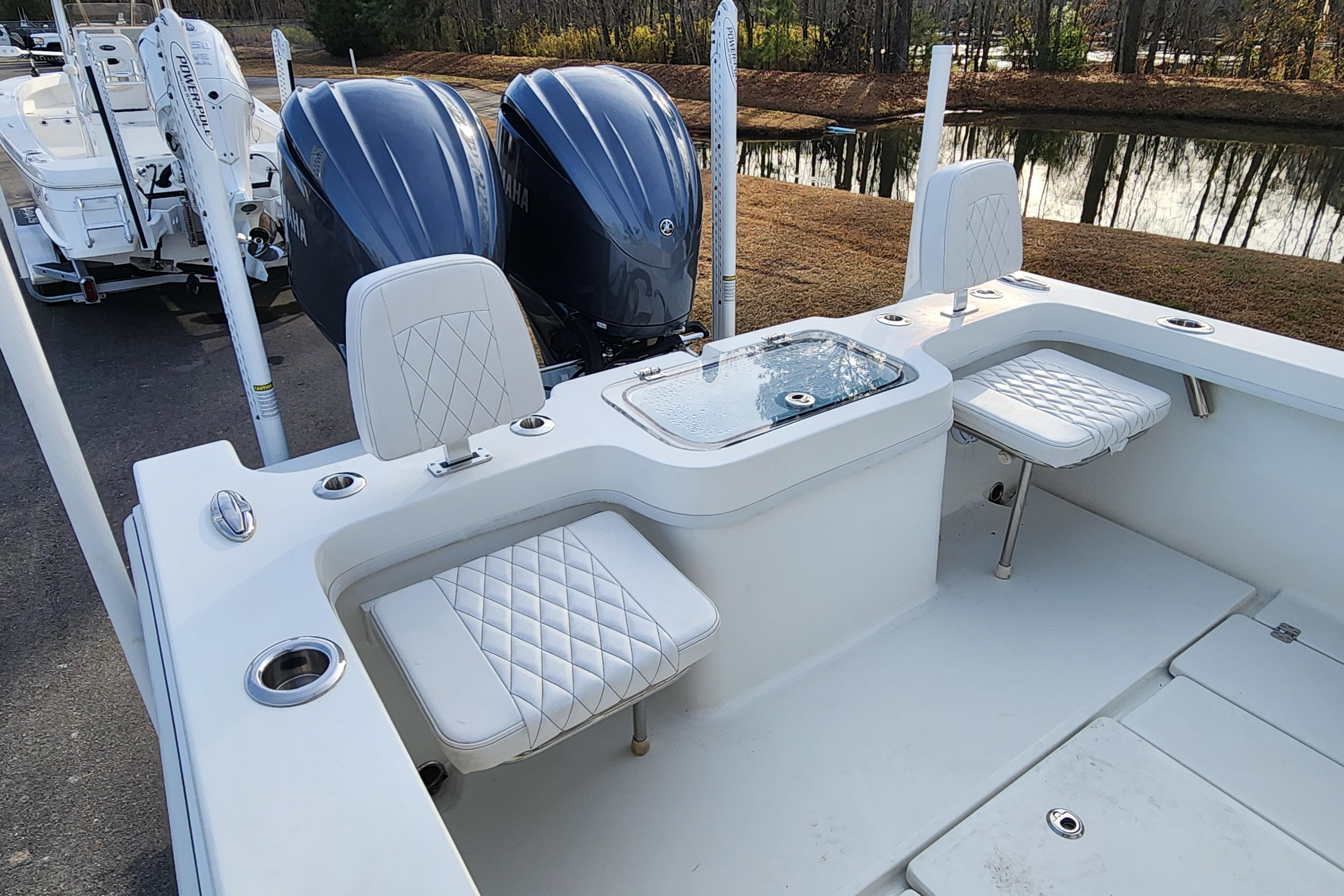 2024 Pair Customs 27 CC boat interior with dual engines and cushioned seating.