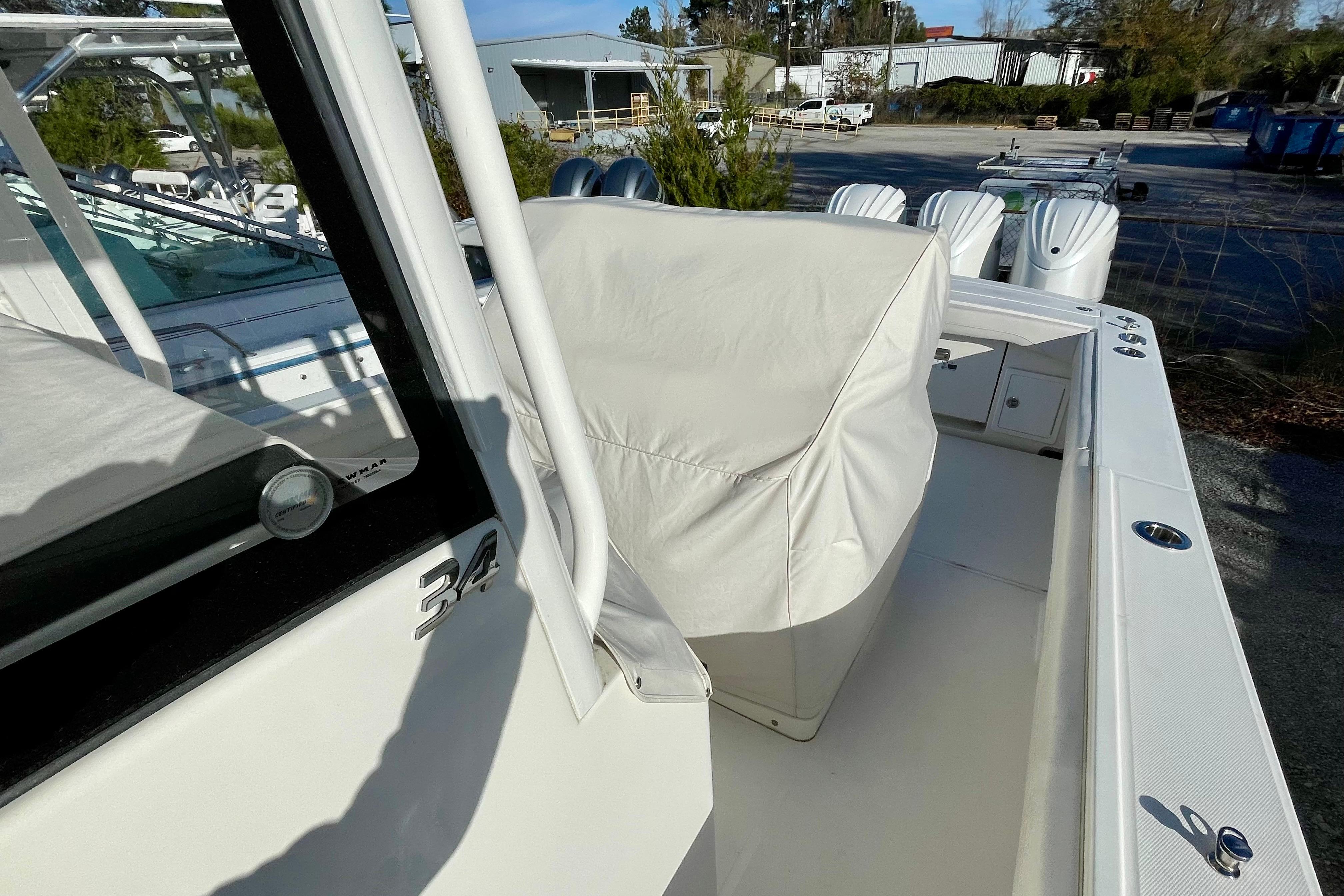 2023 Regulator 34 boat with covered seating, docked outdoors.