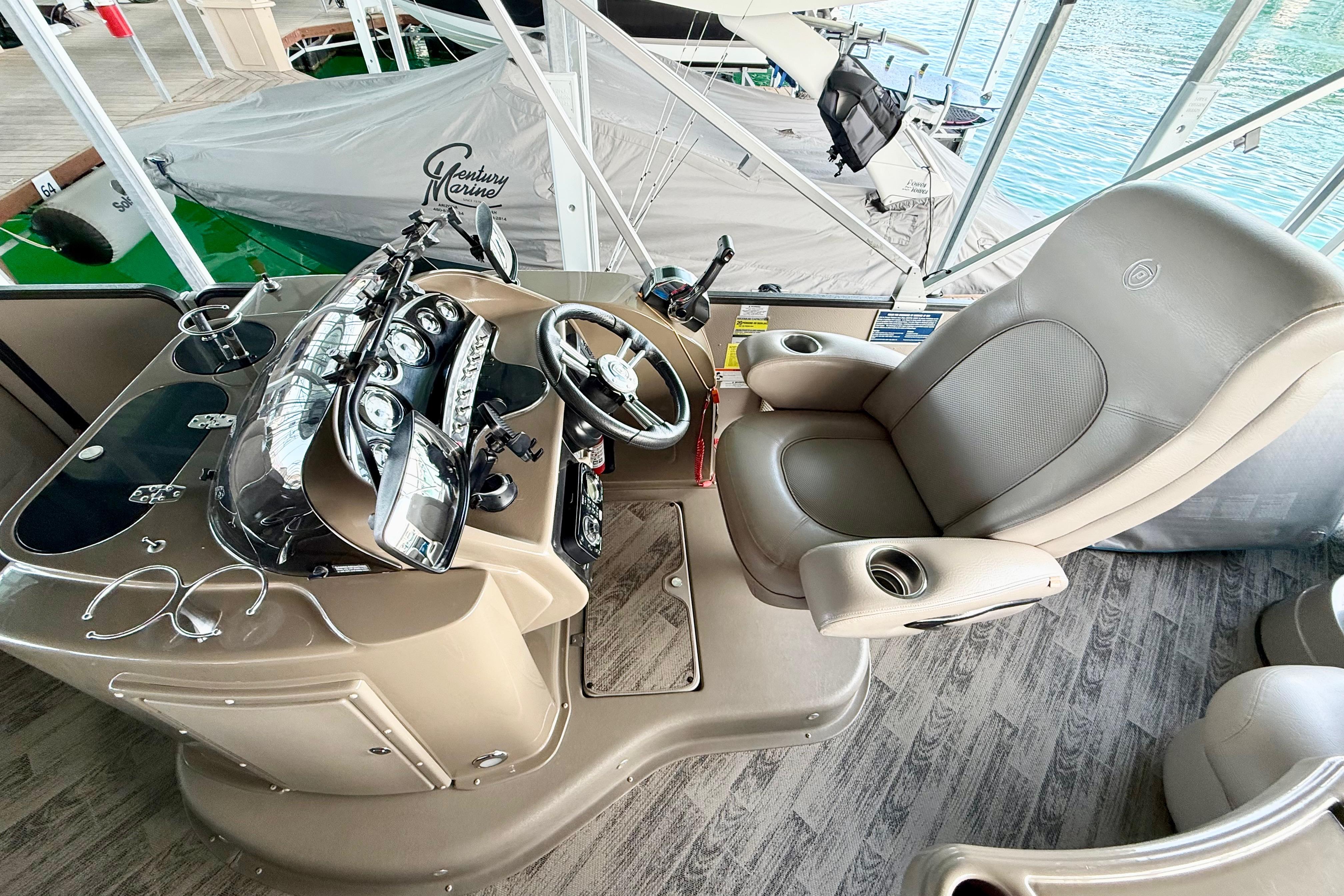 Luxurious helm of 2011 Premier 275 Grand Majestic PTX pontoon boat with plush captain's chair.