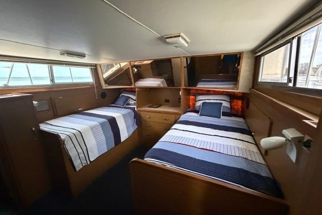 Interior of 1980 Chris-Craft 381 Catalina with twin beds and nautical decor.