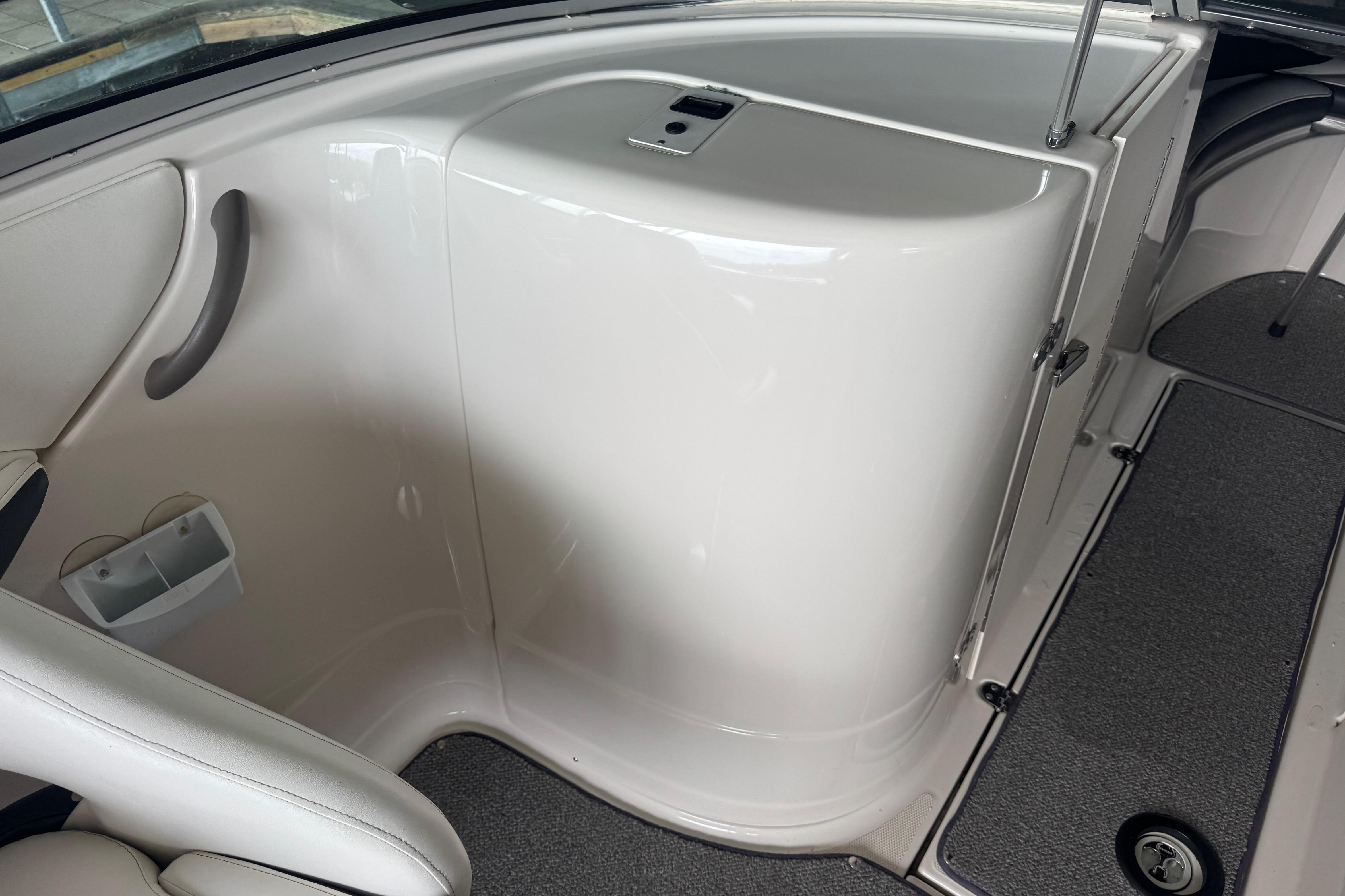 Interior view of a 2005 Monterey 248LS Montura Bowrider boat, featuring sleek white design.
