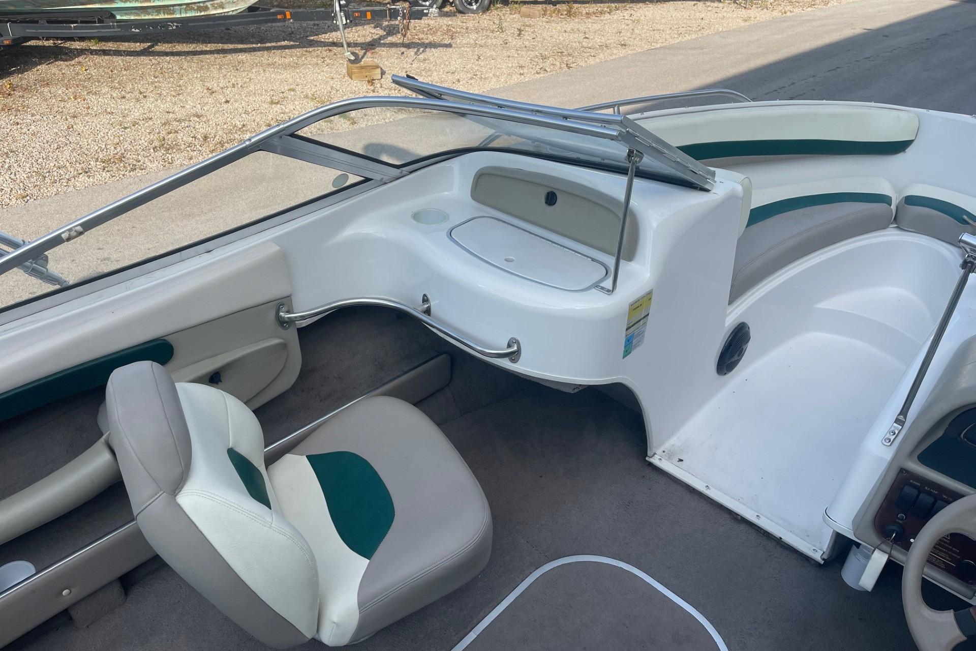 Interior of a 1996 Four Winns 200 Horizon boat, featuring seating and dashboard.