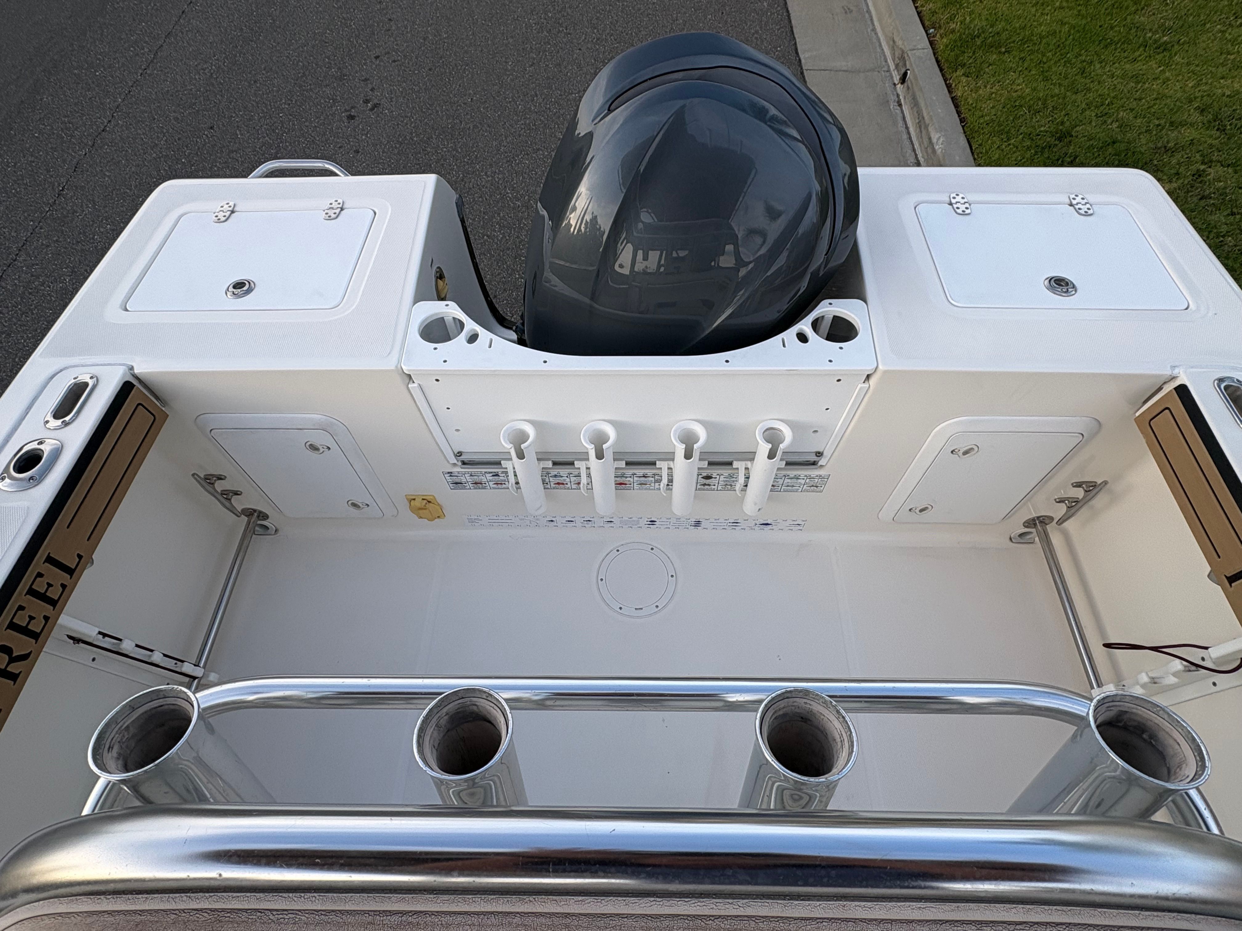 Edgewater 228CC 2008 boat rear with motor and fishing rod holders.