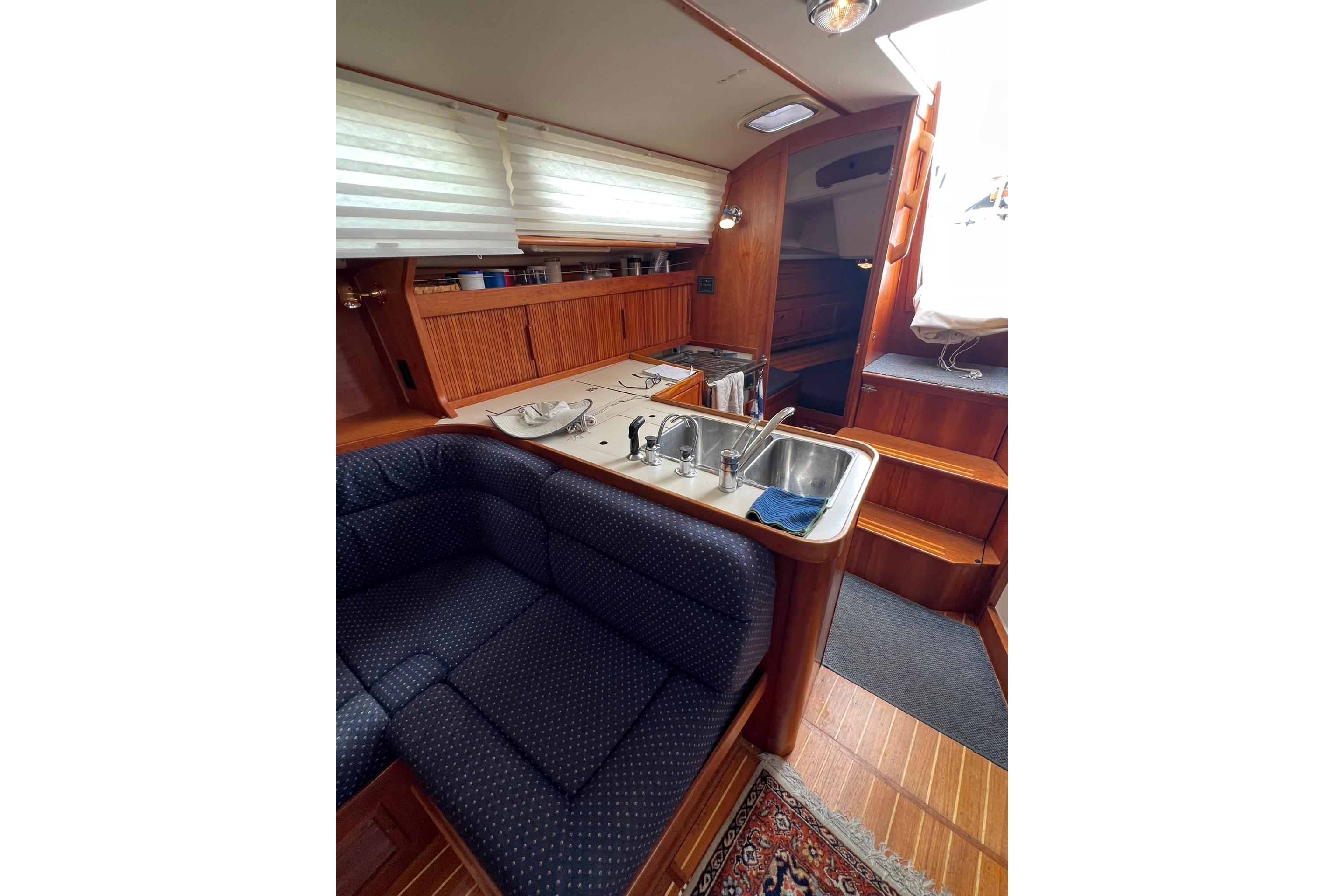 Interior of 1998 Sabre 362 yacht with cozy seating and kitchen area.
