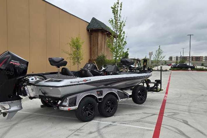 2025 Ranger Z518 boat on trailer in parking lot, overcast sky.