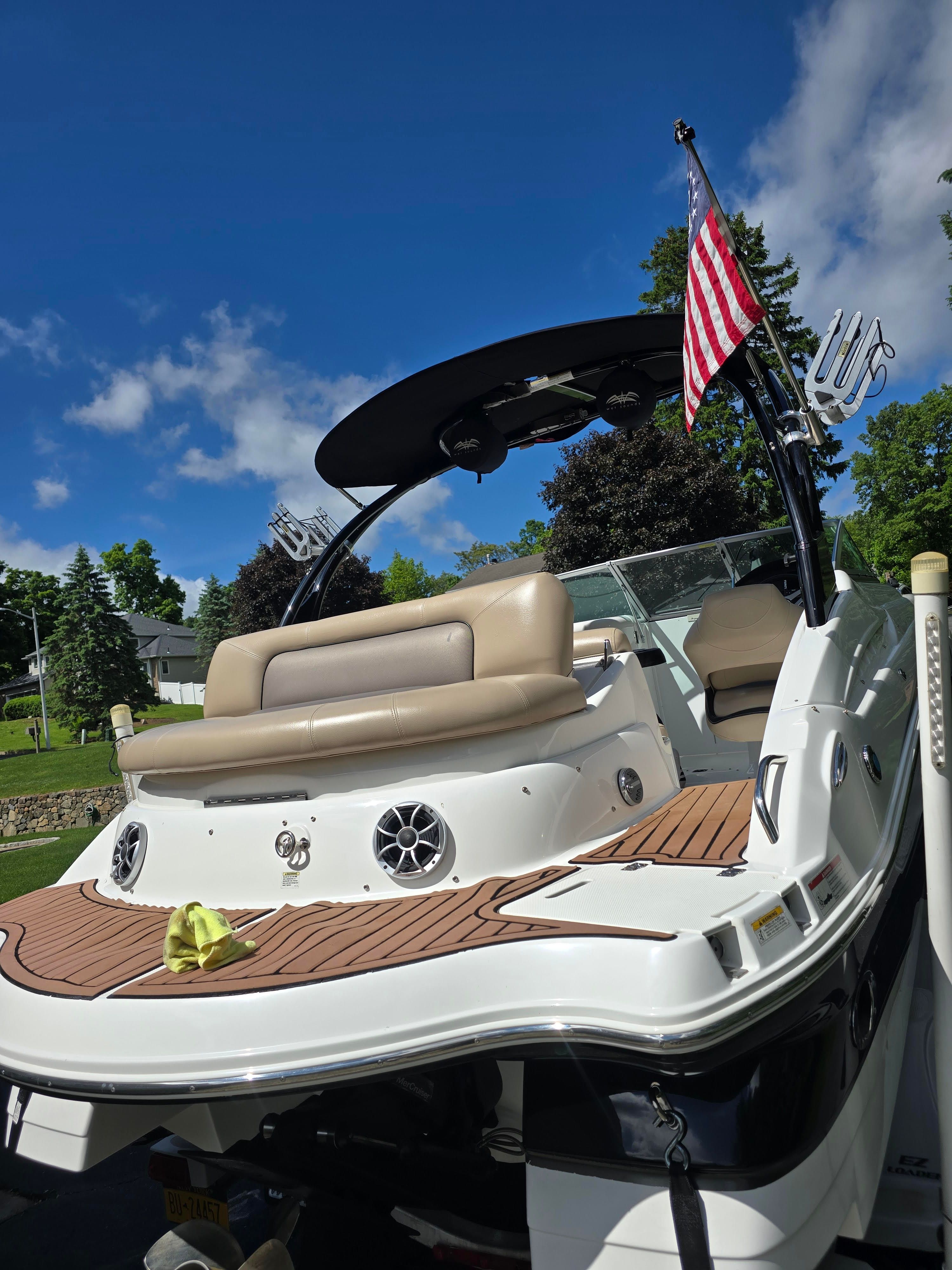 2016 Hurricane SD 2200 boat with American flag, blue sky.