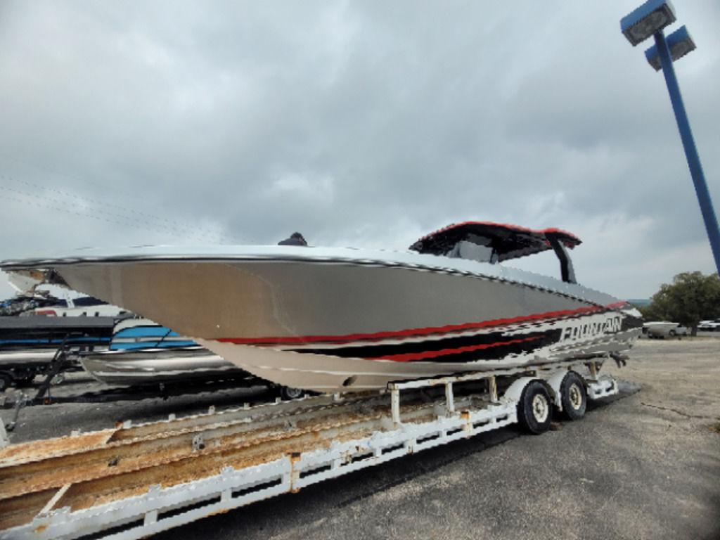 2024 Fountain 38 SCX boat on trailer, sleek design, overcast sky background.