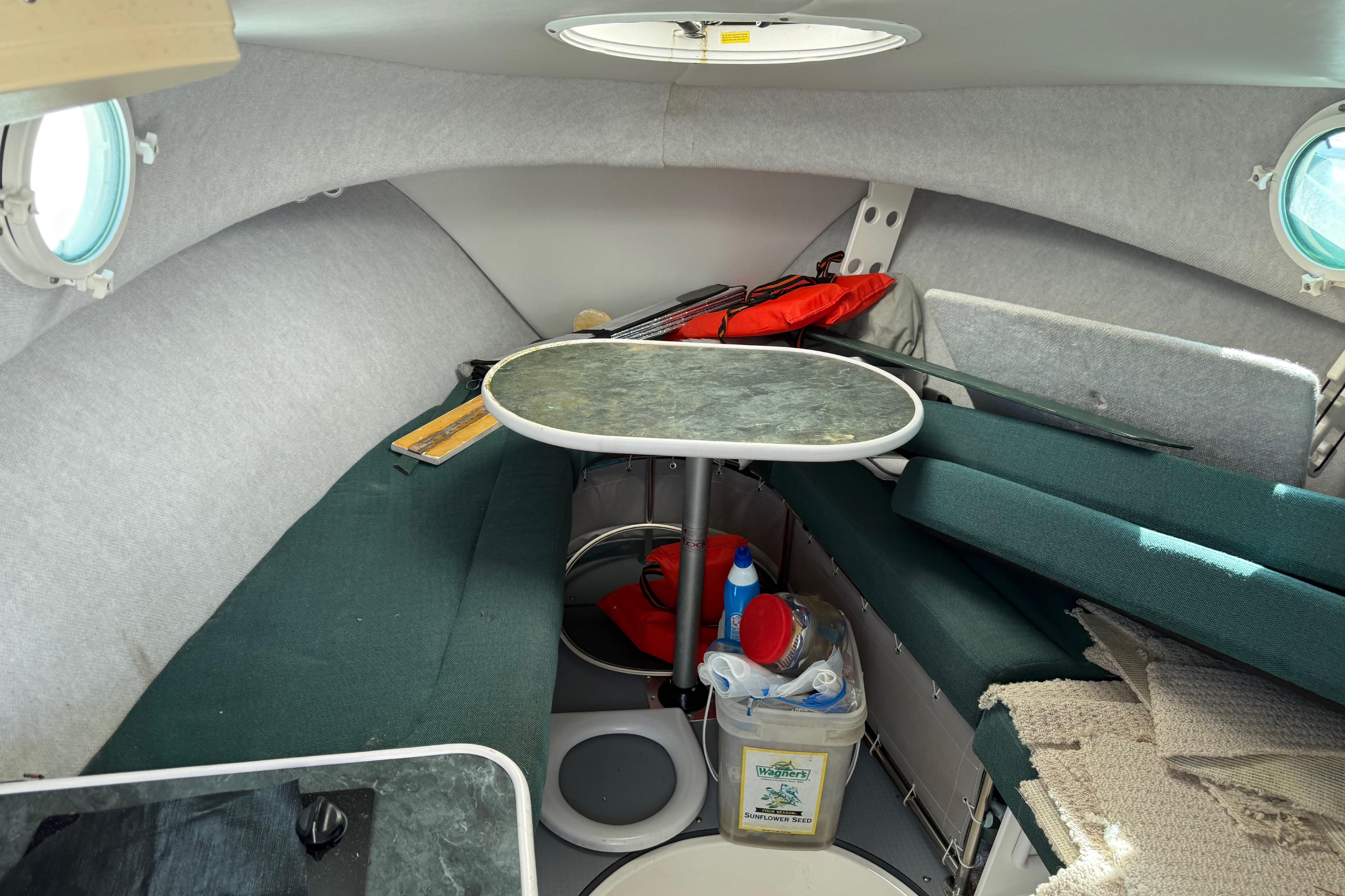 Interior of a 2006 Trophy 2502 Walkaround boat with seating and table.