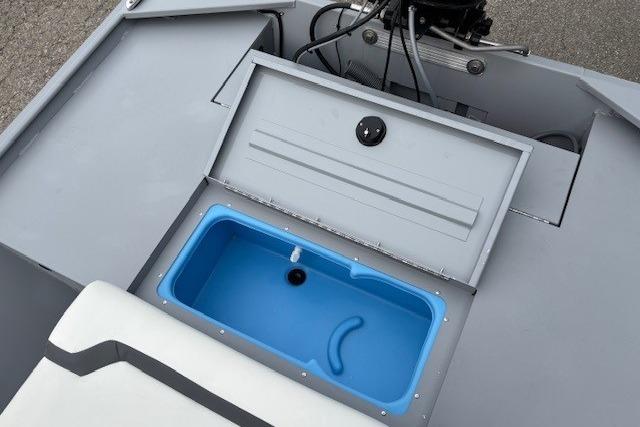 2026 Tracker Bass Tracker Classic CC boat with open storage compartment and blue interior.