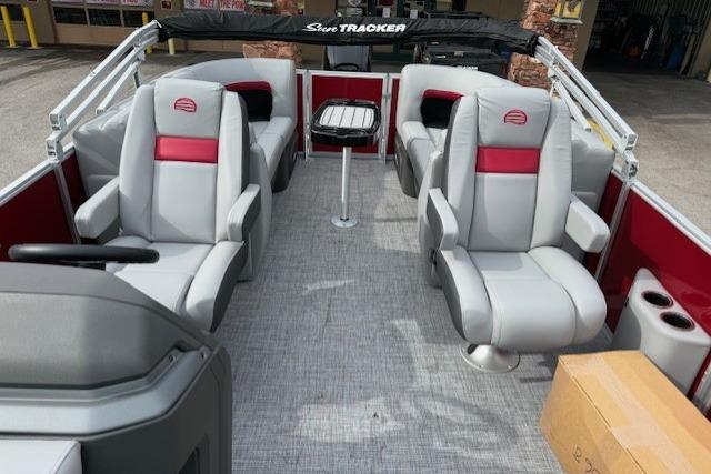 2026 Sun Tracker Party Barge 22 DLX interior with plush seating and table.