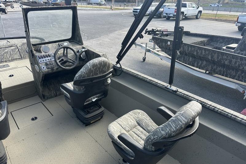 2025 SeaArk Predator 300 AK boat interior with camo seats and steering console.