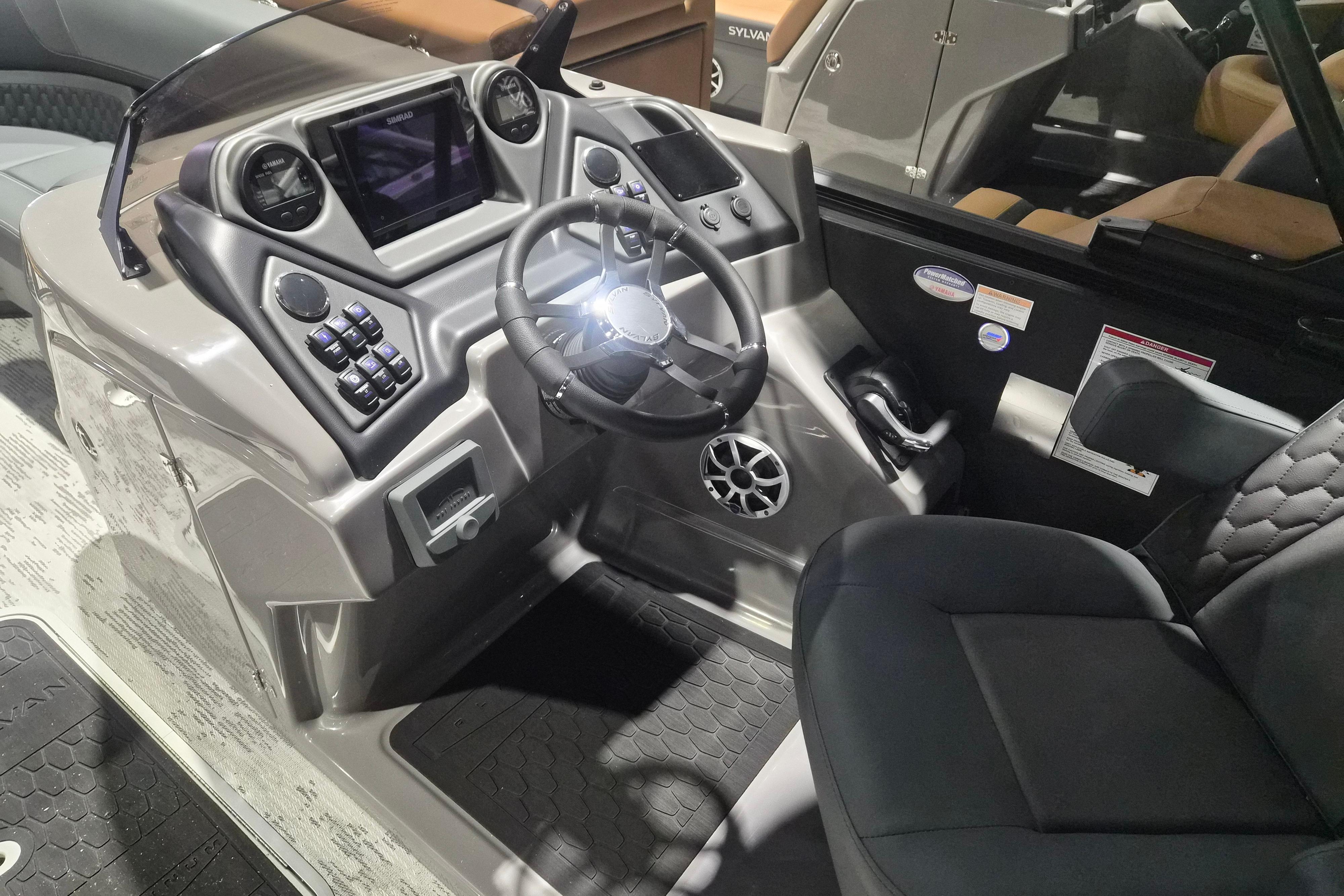 2026 Sylvan L3 ULZ boat dashboard with steering wheel and control panel.