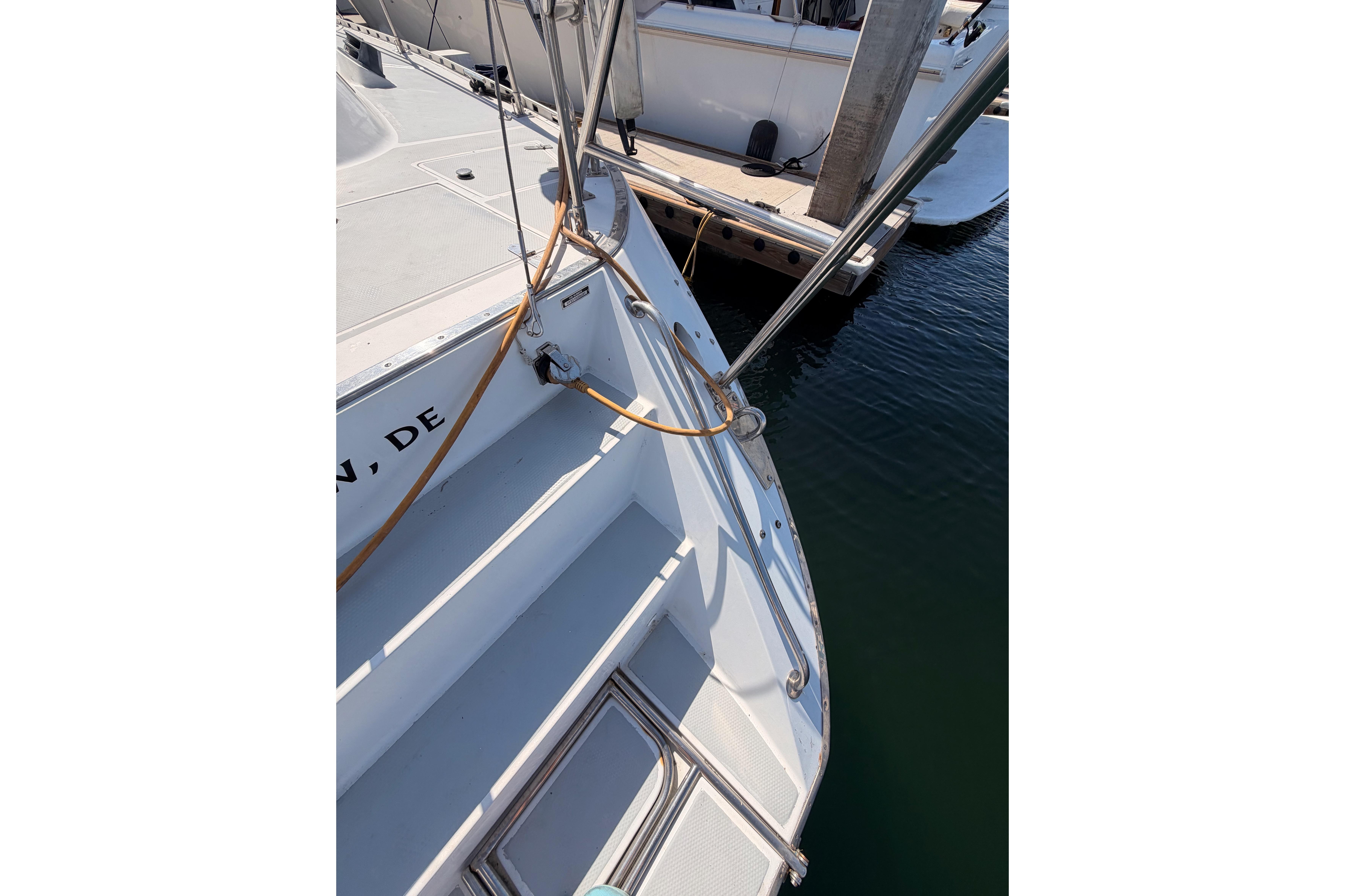 Stern view of a 1991 Hylas 51 yacht docked at a marina.
