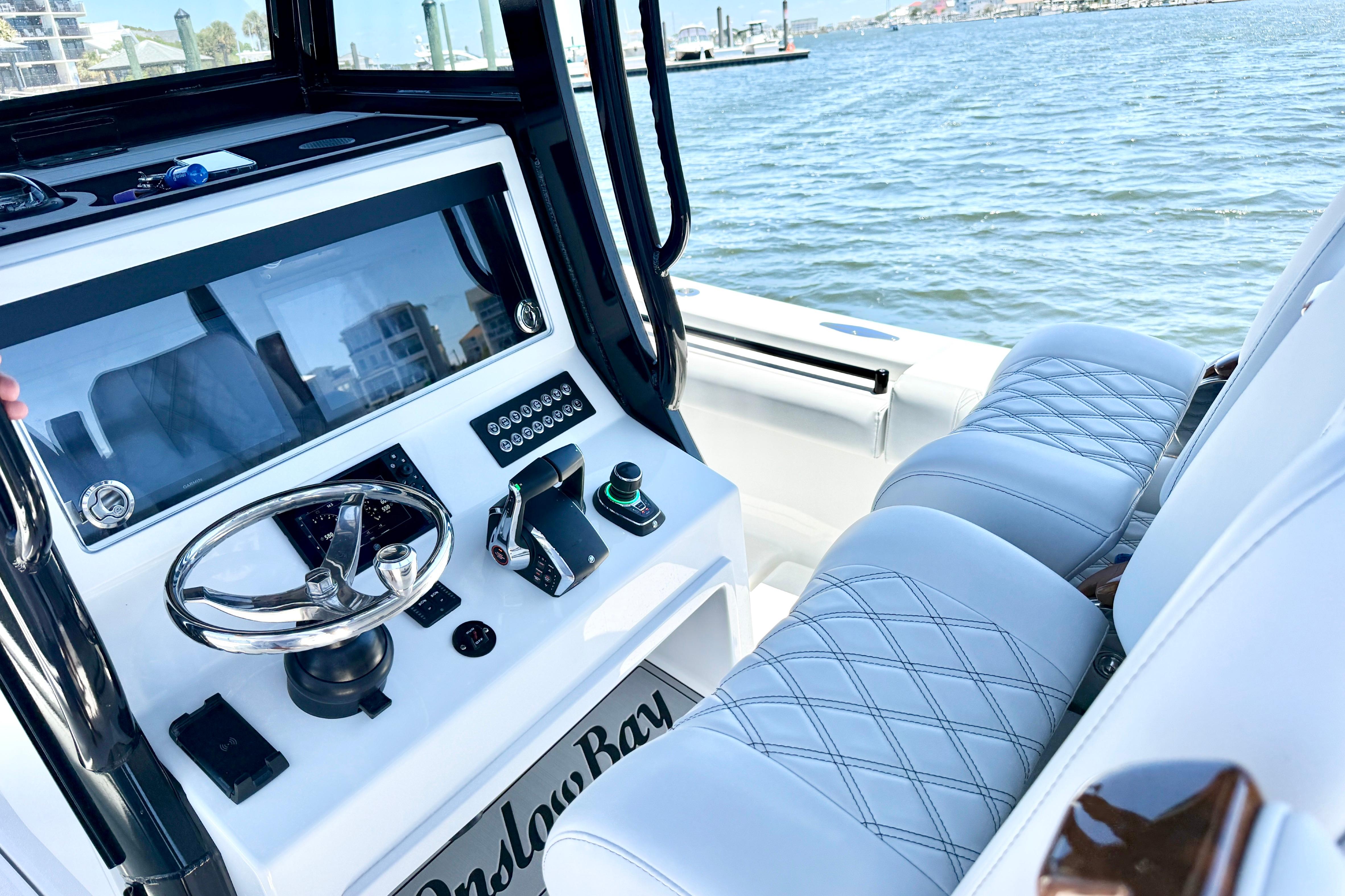 2026 Onslow Bay boat interior with modern steering console and luxurious seating.