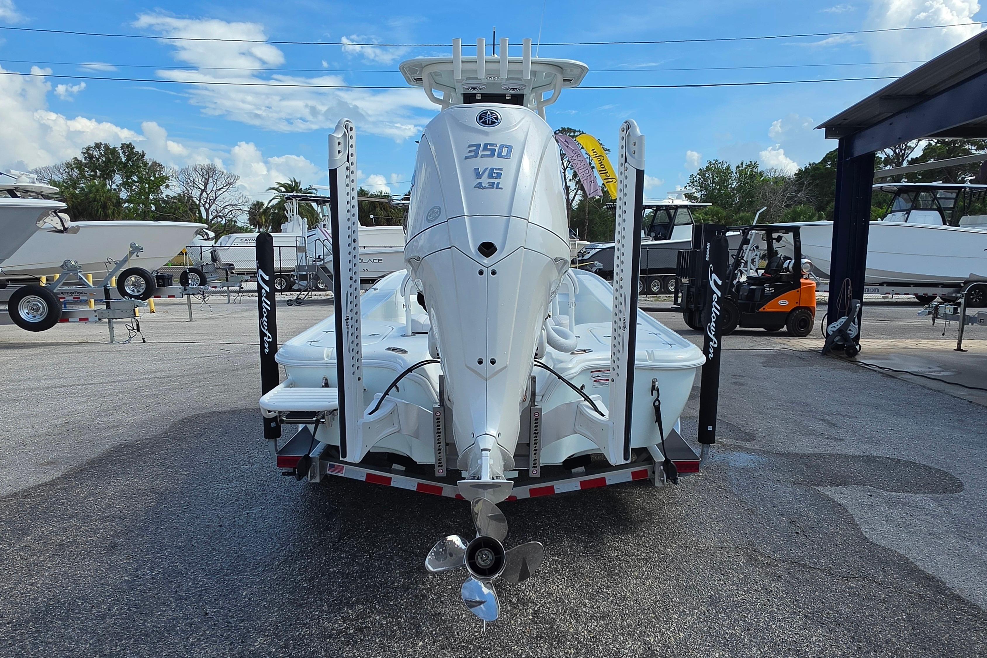 2026 Yellowfin 24 Bay CE boat with powerful 350 V6 engine, displayed outdoors.