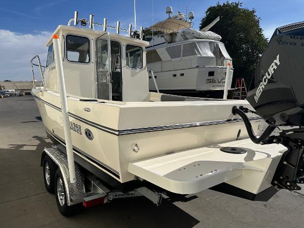 2023 Defiance Admiral 220 EX boat on trailer, featuring Mercury outboard motor.
