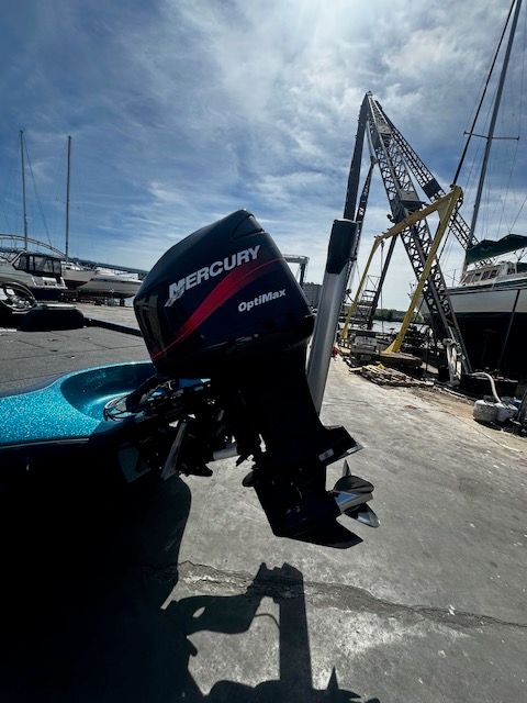 Ranger 520 VX 2000 with Mercury OptiMax outboard motor at the harbor.