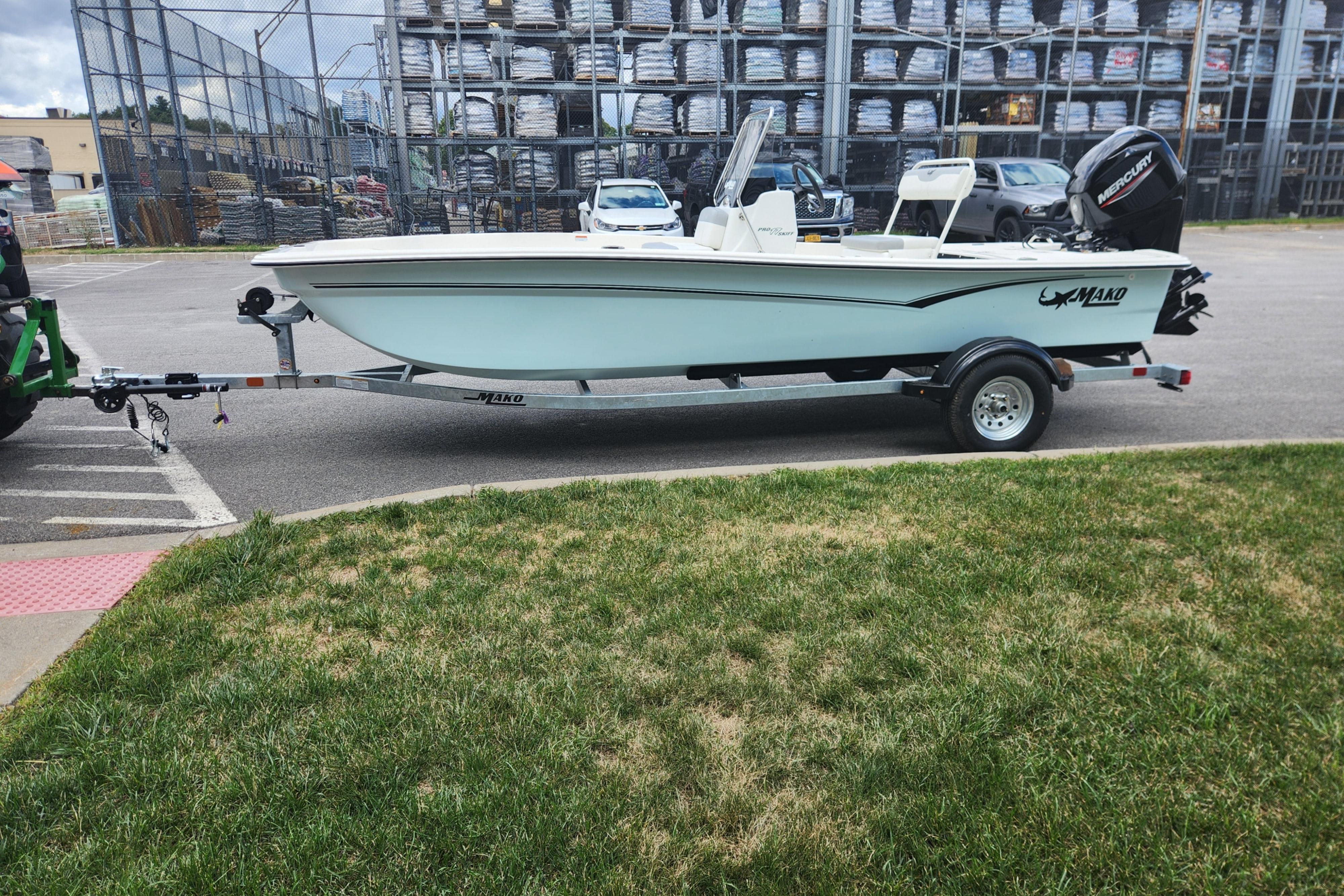 2026 Mako Pro Skiff 17 CC boat on trailer in parking lot.