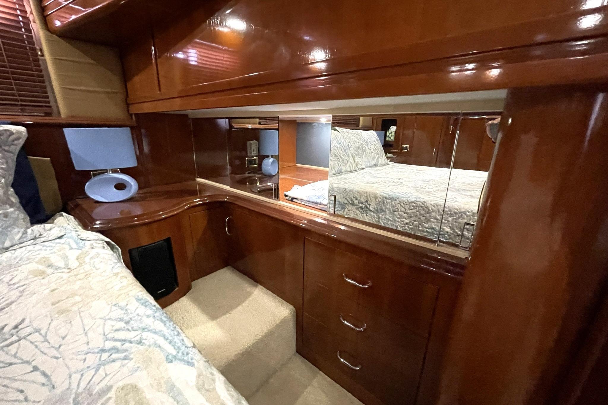 CUSTOM MIRRORED HIDDEN STORAGE VANITY AREA AFT OF MASTER BED