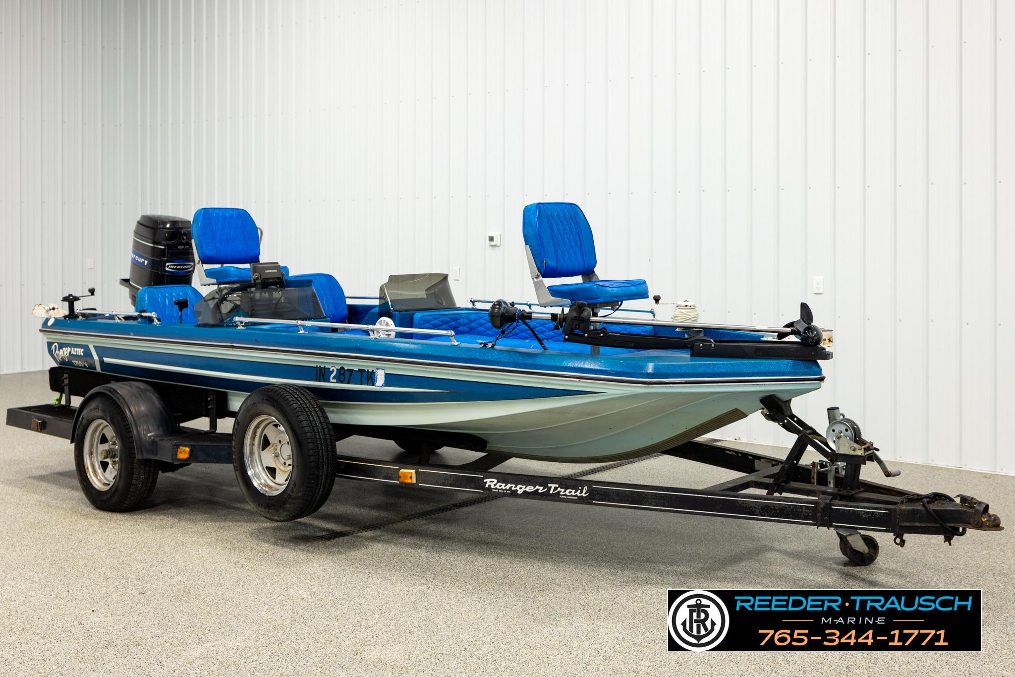 1980 Ranger 175 VS boat on trailer, blue seats, displayed indoors at Reeder-Trausch Marine.