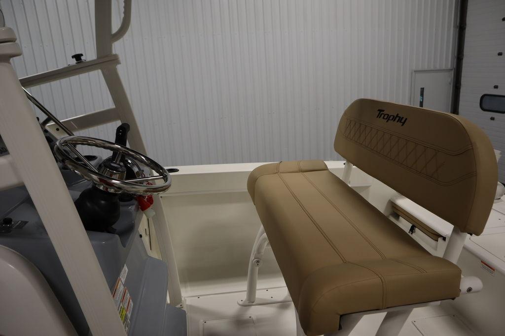 2026 Bayliner Trophy T20CC boat interior with steering wheel and tan seating.
