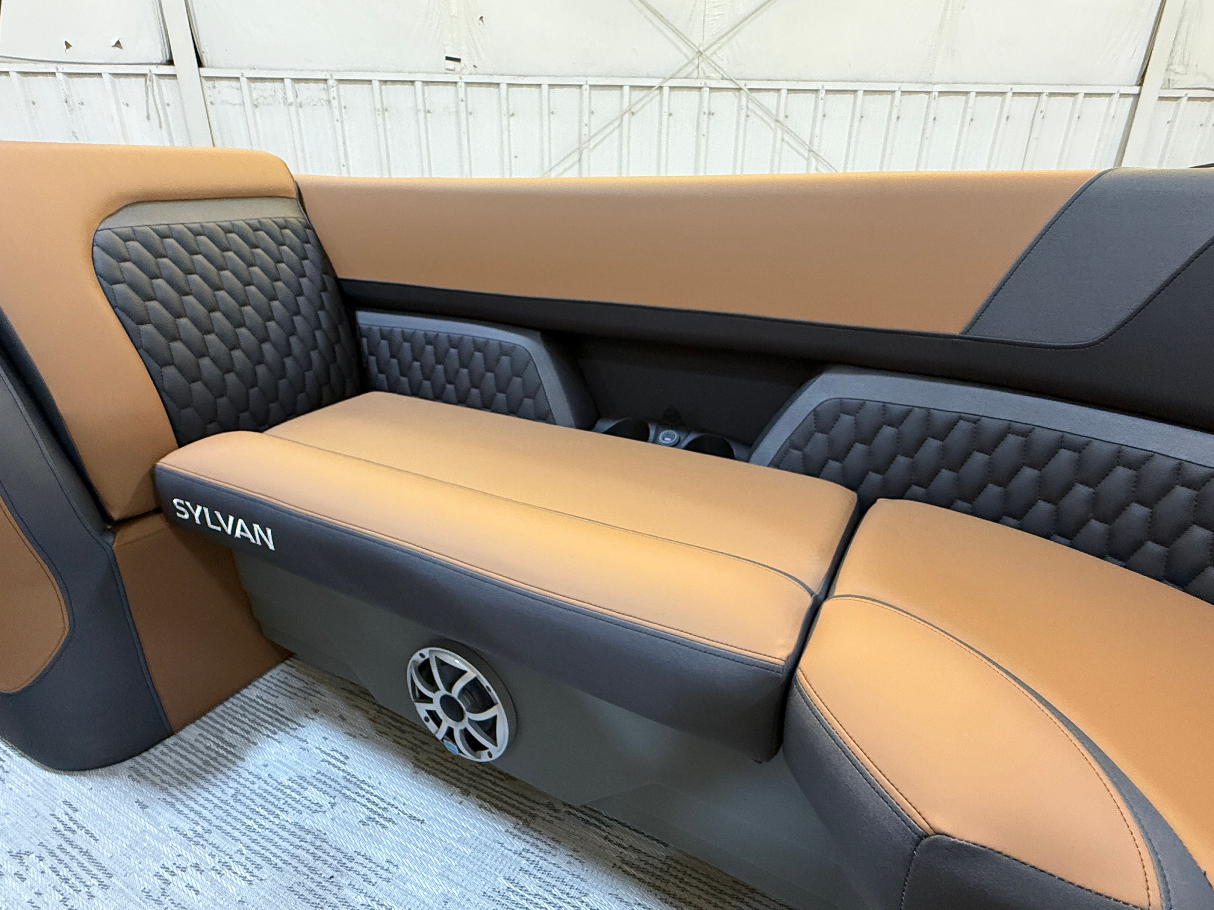 The image shows a luxurious boat seat with brown and gray upholstery.