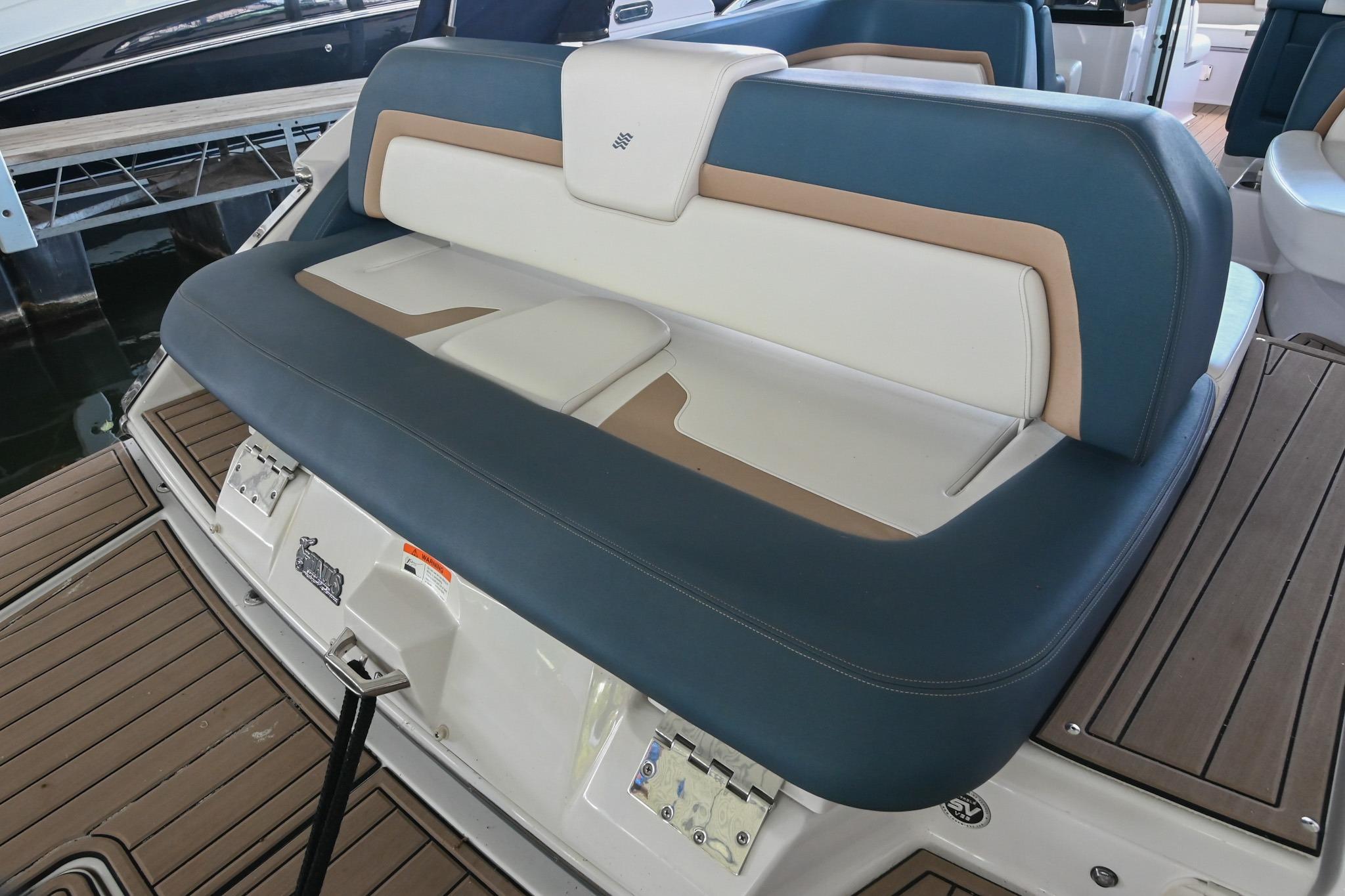 2014 Four Winns H290 boat seating with blue and white upholstery on deck.