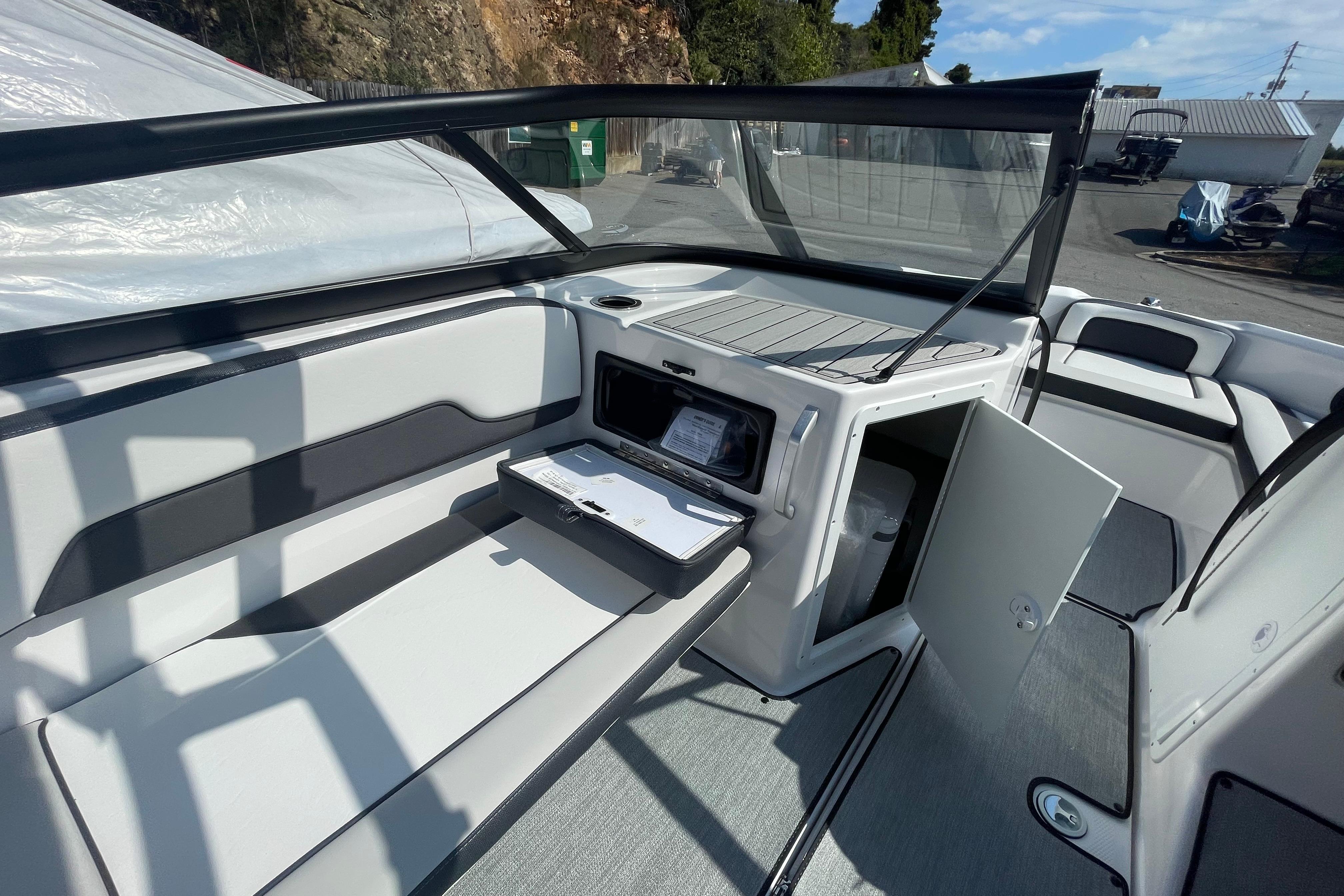 2026 Yamaha Boats AR195 interior with open storage compartments and seating area.