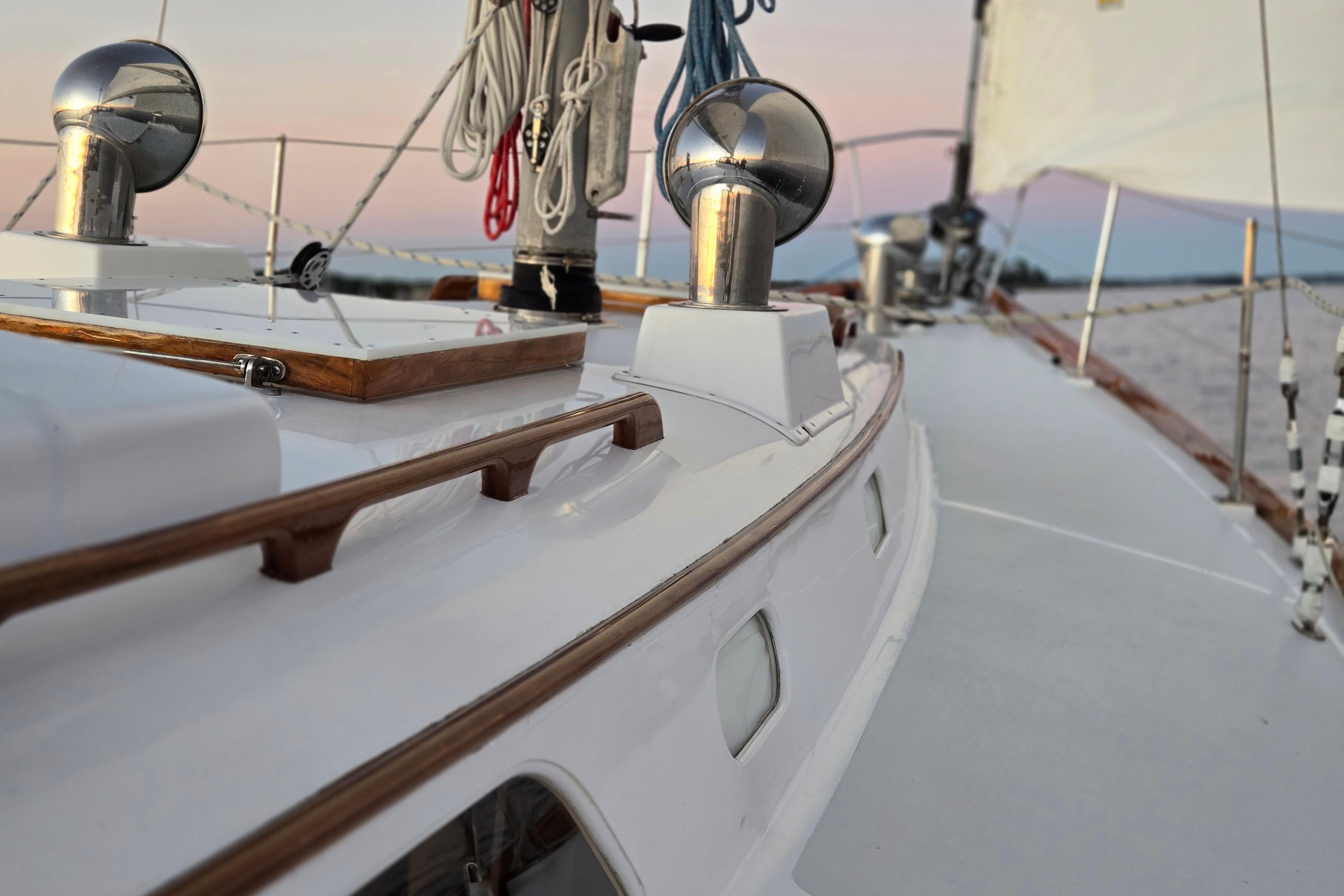 1970 Hinckley Bermuda 40 sailboat deck with ropes and polished fittings at sunset.