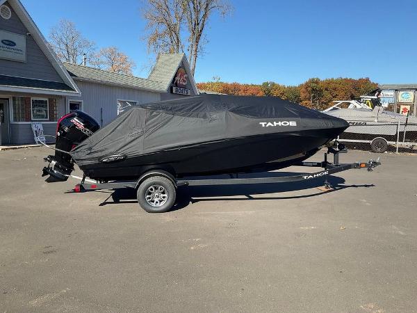 2025 Tahoe T18 boat covered on trailer in outdoor setting.