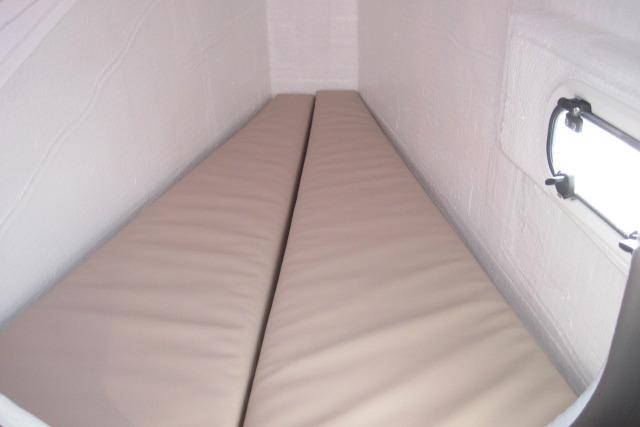 Cozy cabin bed in 2020 Bali 4.3 yacht with side window.