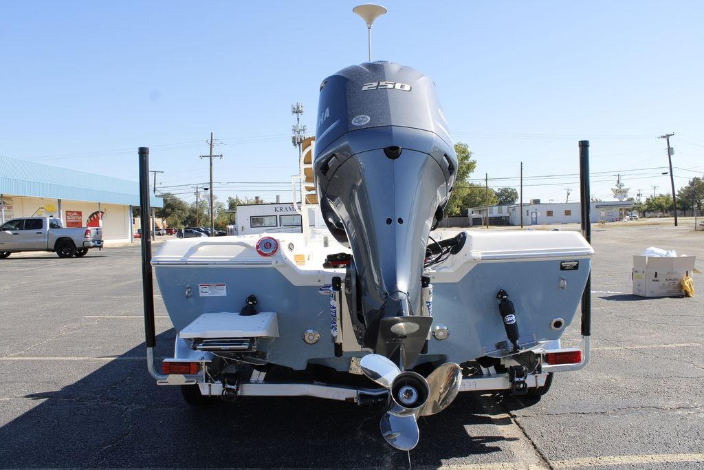 2026 Skeeter SX230 boat with powerful outboard motor in a parking lot.