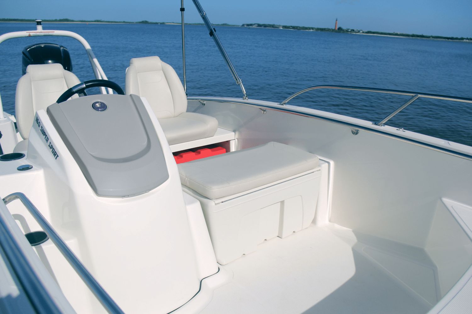 The image shows the cockpit of a Boston Whaler 160 Super Sport boat on calm water.