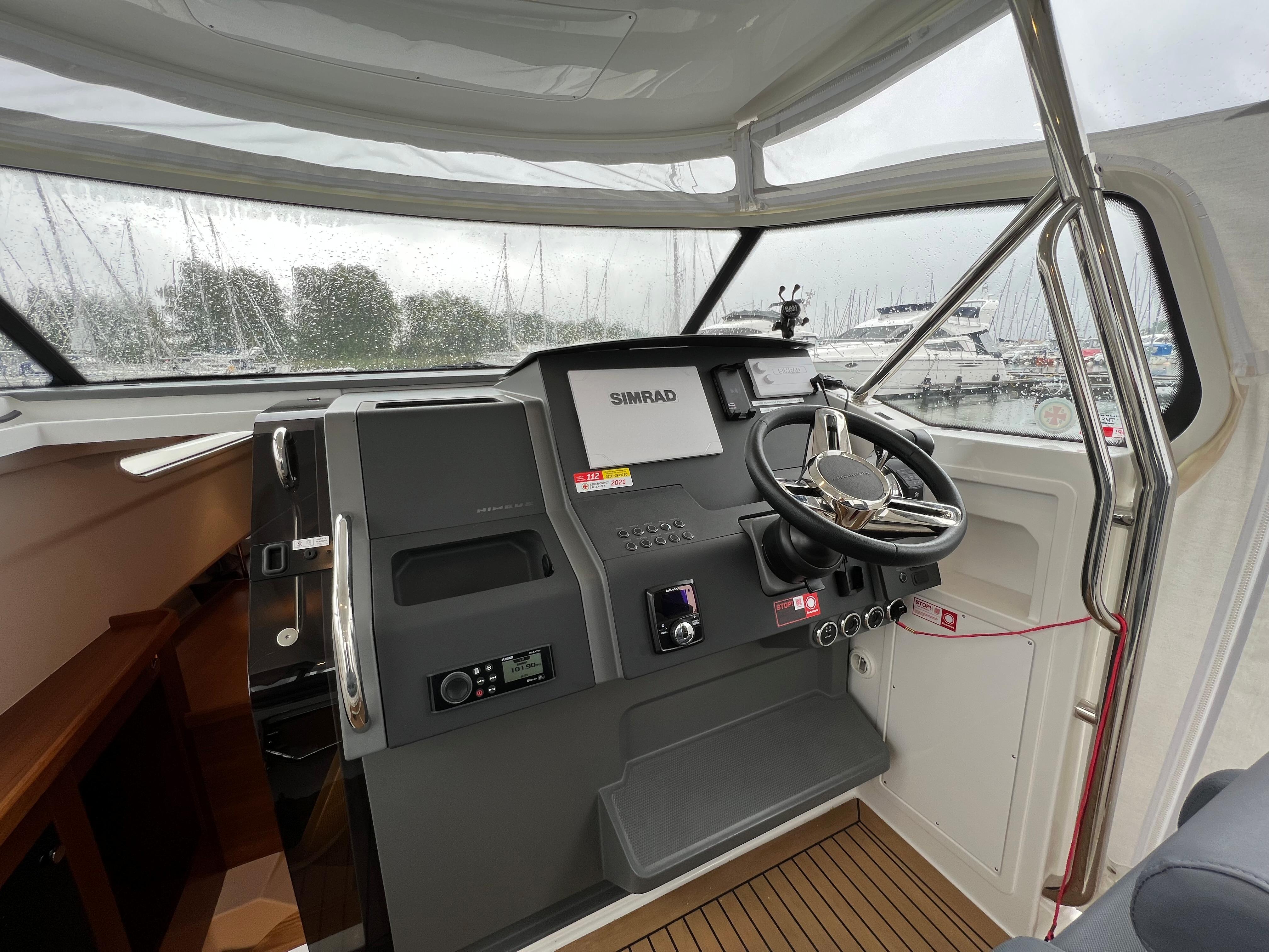 2021 Nimbus Tender 11 helm with Simrad navigation, sleek design, and modern controls.