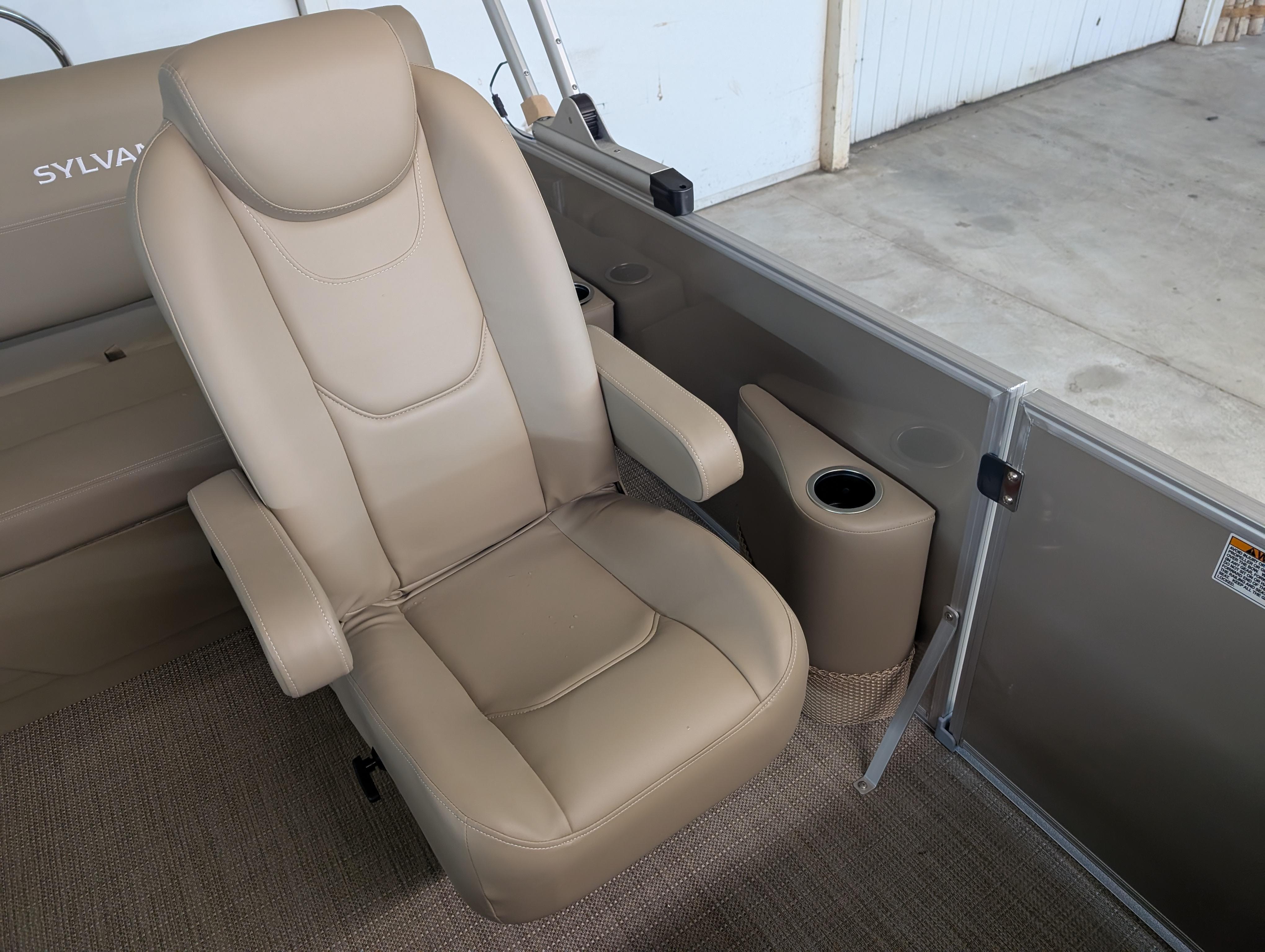Beige captain's chair in 2025 Sylvan Mirage Cruise 8520 CLZ DH pontoon boat interior.