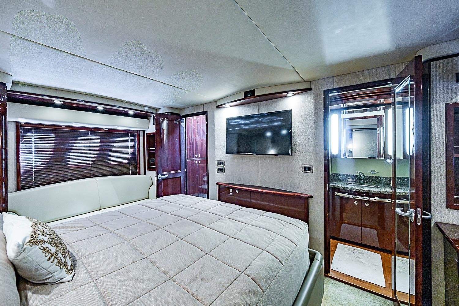 Luxurious bedroom interior of 2008 Sea Ray 60 Sundancer yacht with ensuite bathroom.