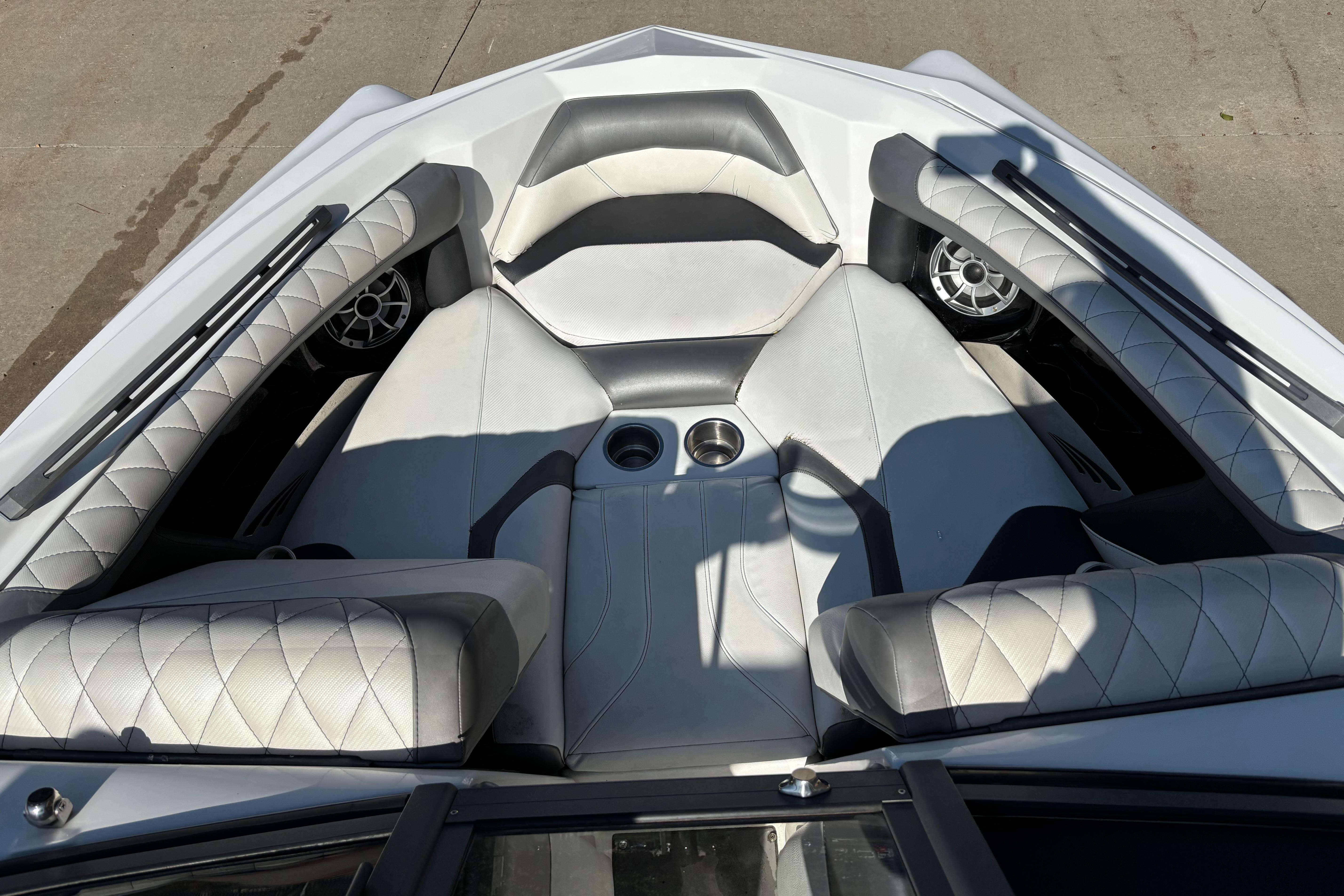 2014 Tigé RZR boat interior with white quilted seats and cup holders.
