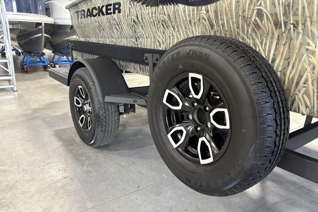 2026 Tracker Grizzly 1650 T Prairie Wings Edition trailer with camo design and black alloy wheels.