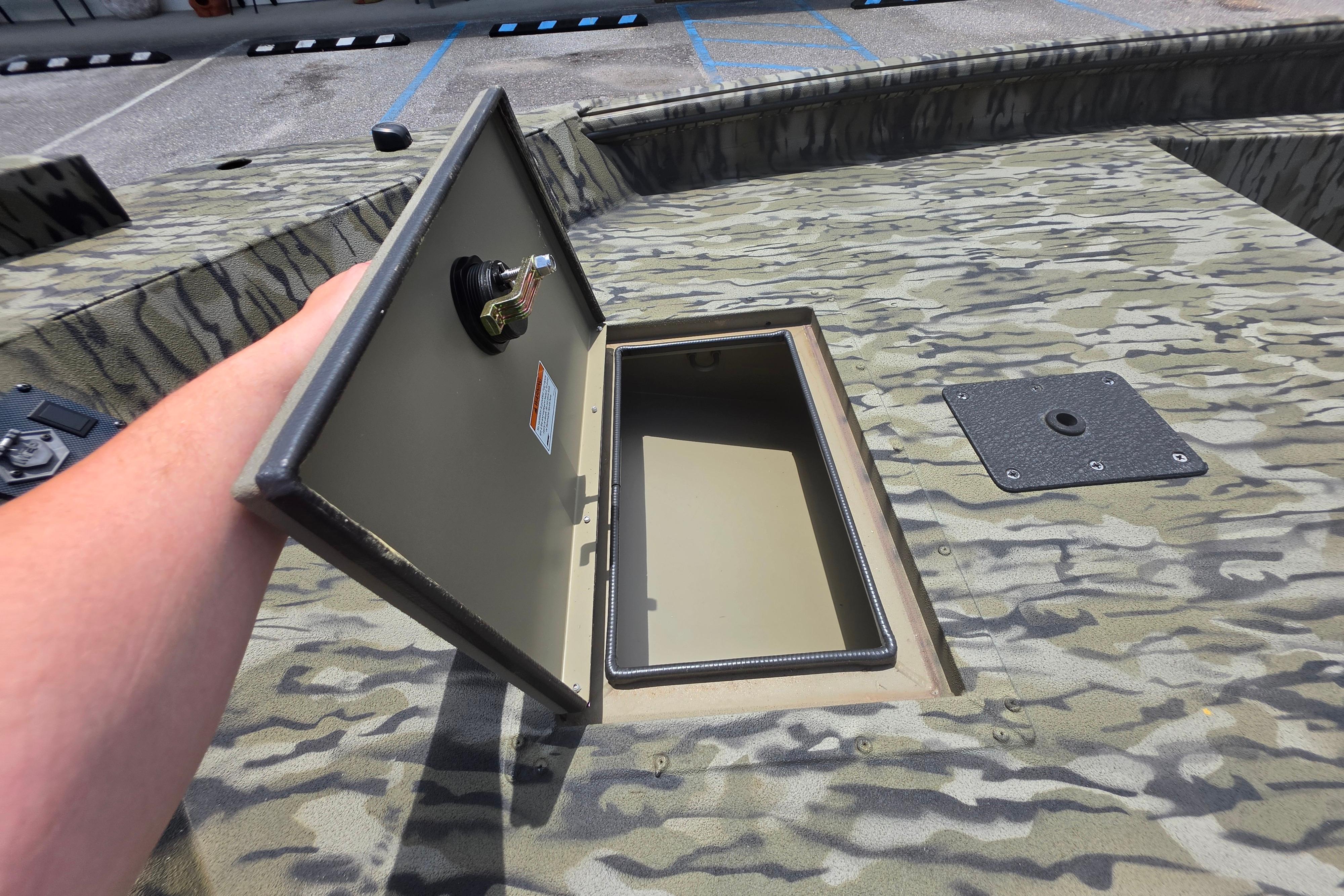 2025 SeaArk 1752 Slayer boat with open storage compartment, camo pattern deck.