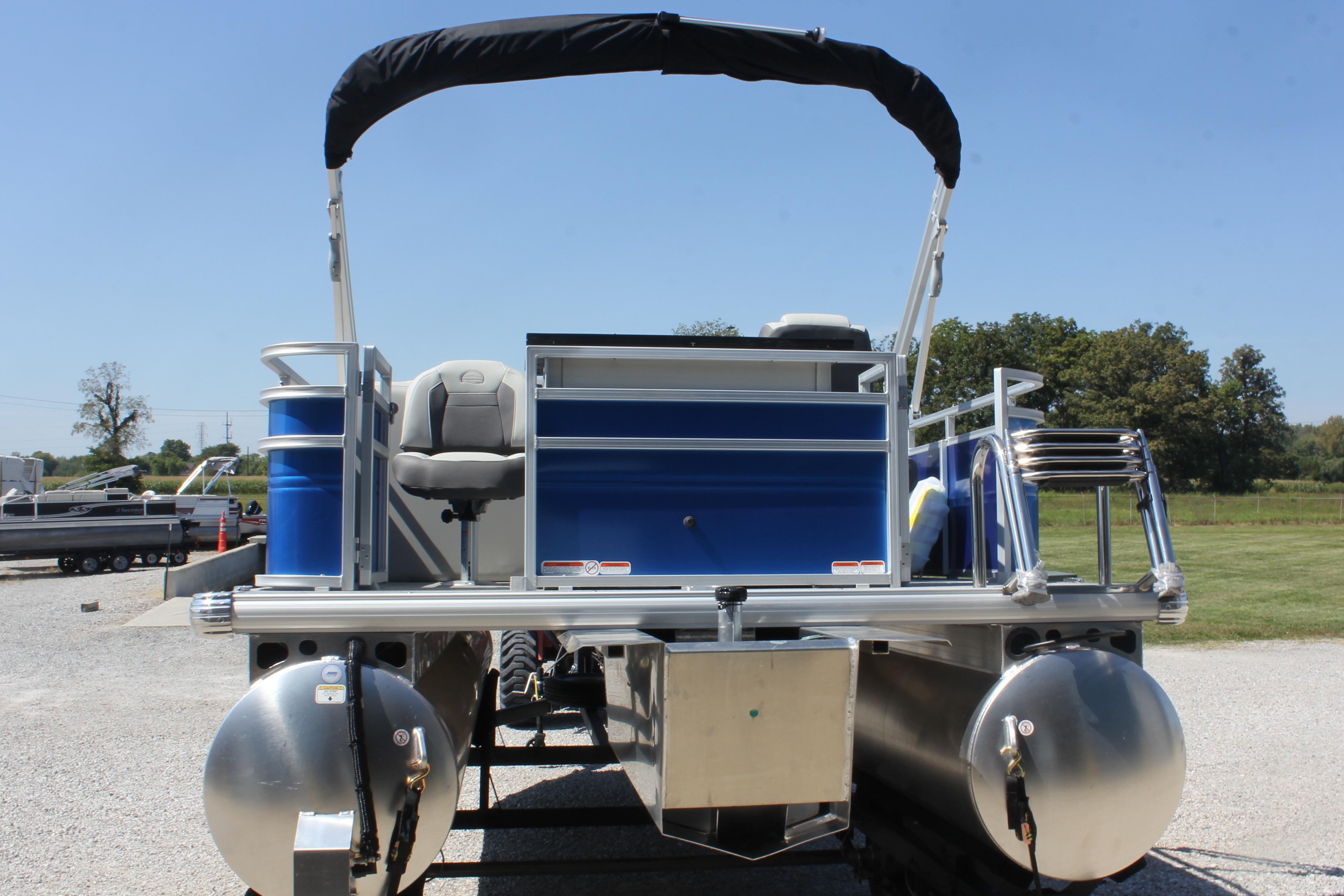 2026 Sun Tracker Fishin' Barge 20 DLX pontoon boat, rear view, parked outdoors.