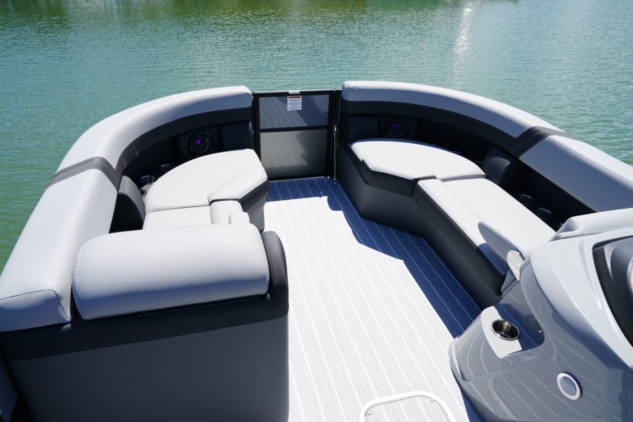 Luxurious seating on 2026 Berkshire 24 RFX CTS pontoon boat, overlooking serene water.