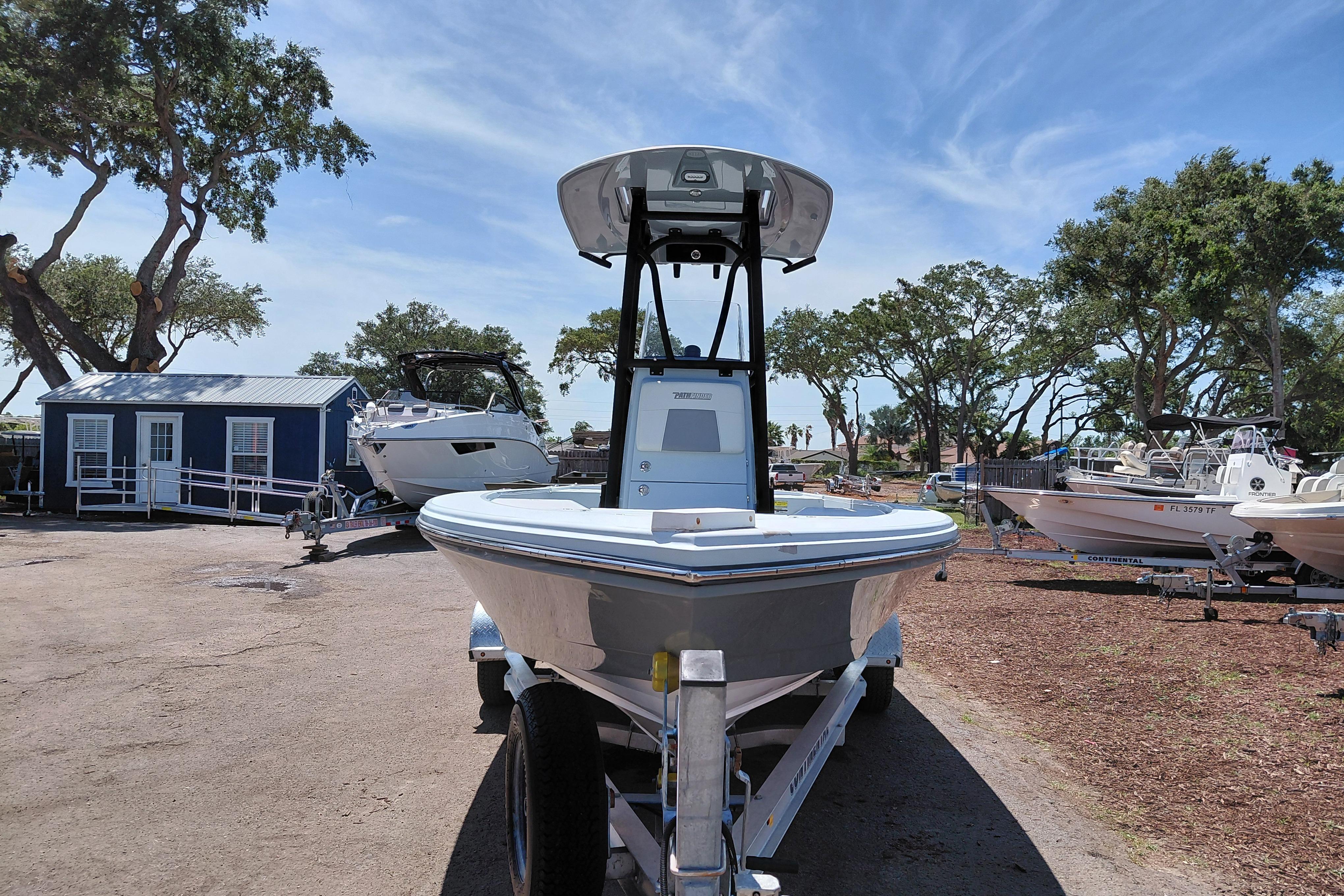 2022 Pathfinder 2300 HPS boat on trailer, parked outdoors under clear sky.