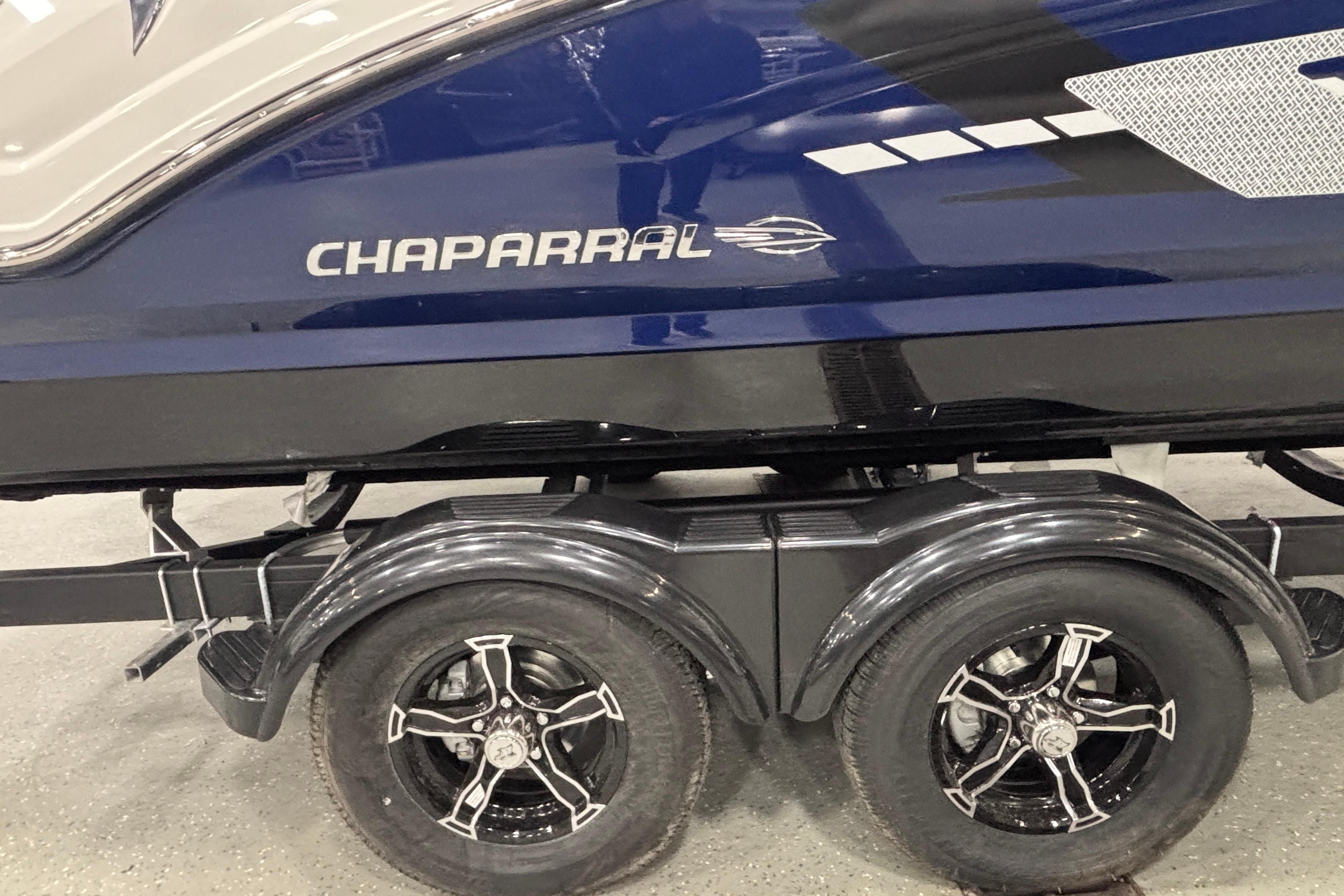 2026 Chaparral 23 SSi boat on trailer, featuring sleek design and dual wheels.