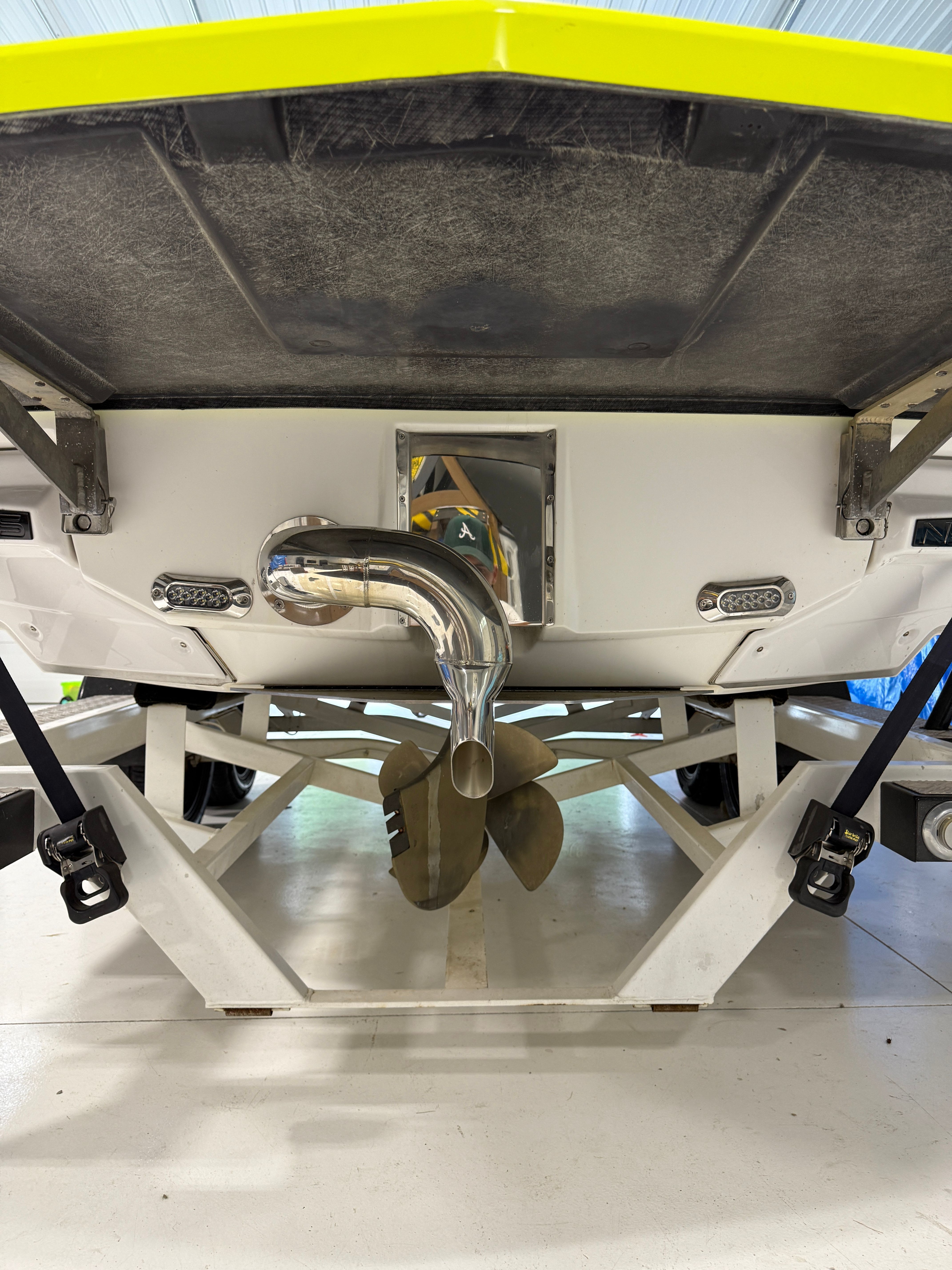 Rear view of a 2016 Nautique Super Air Nautique G23 with visible propeller and exhaust.