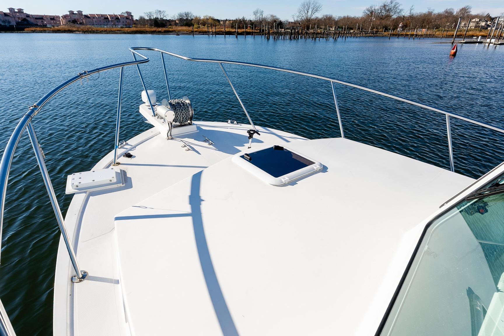 2024 Steiger Craft 31 Fisherman boat on calm water, showcasing bow and railing.