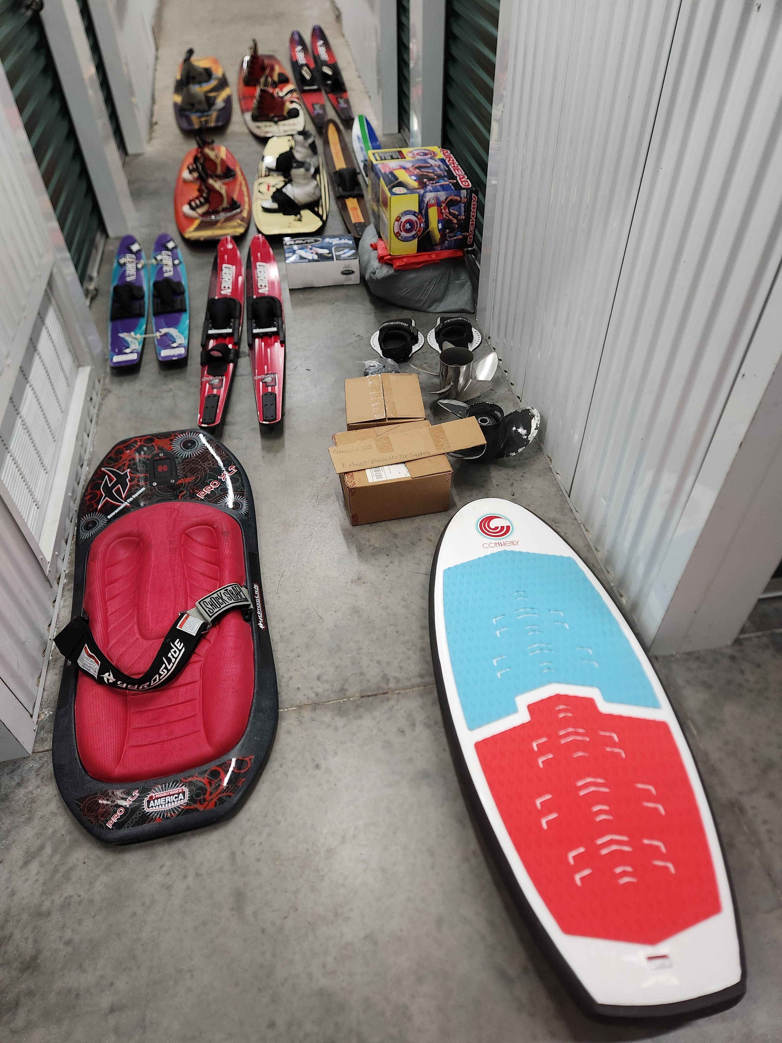Watersports gear in storage, including kneeboards and water skis.